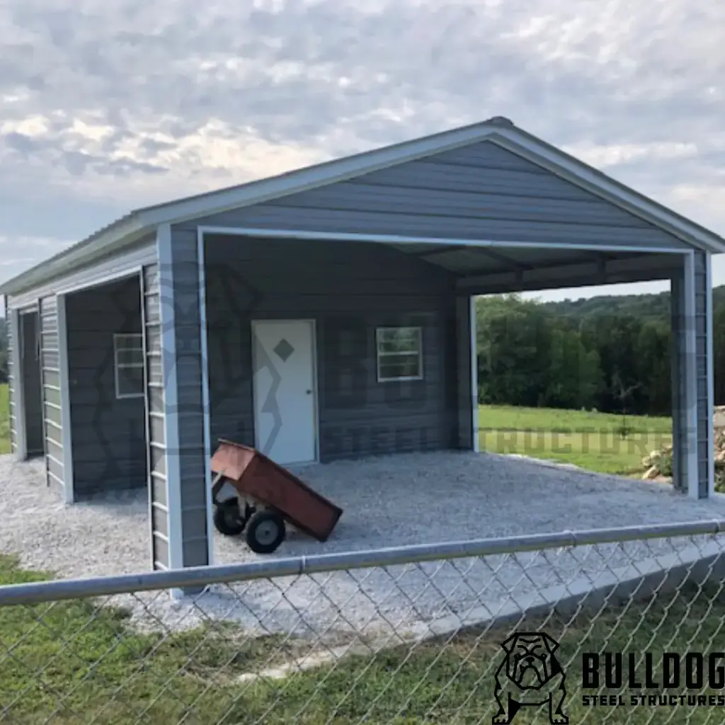 Metal carport with attached shed on gravel driveway, located in rural grassy area
