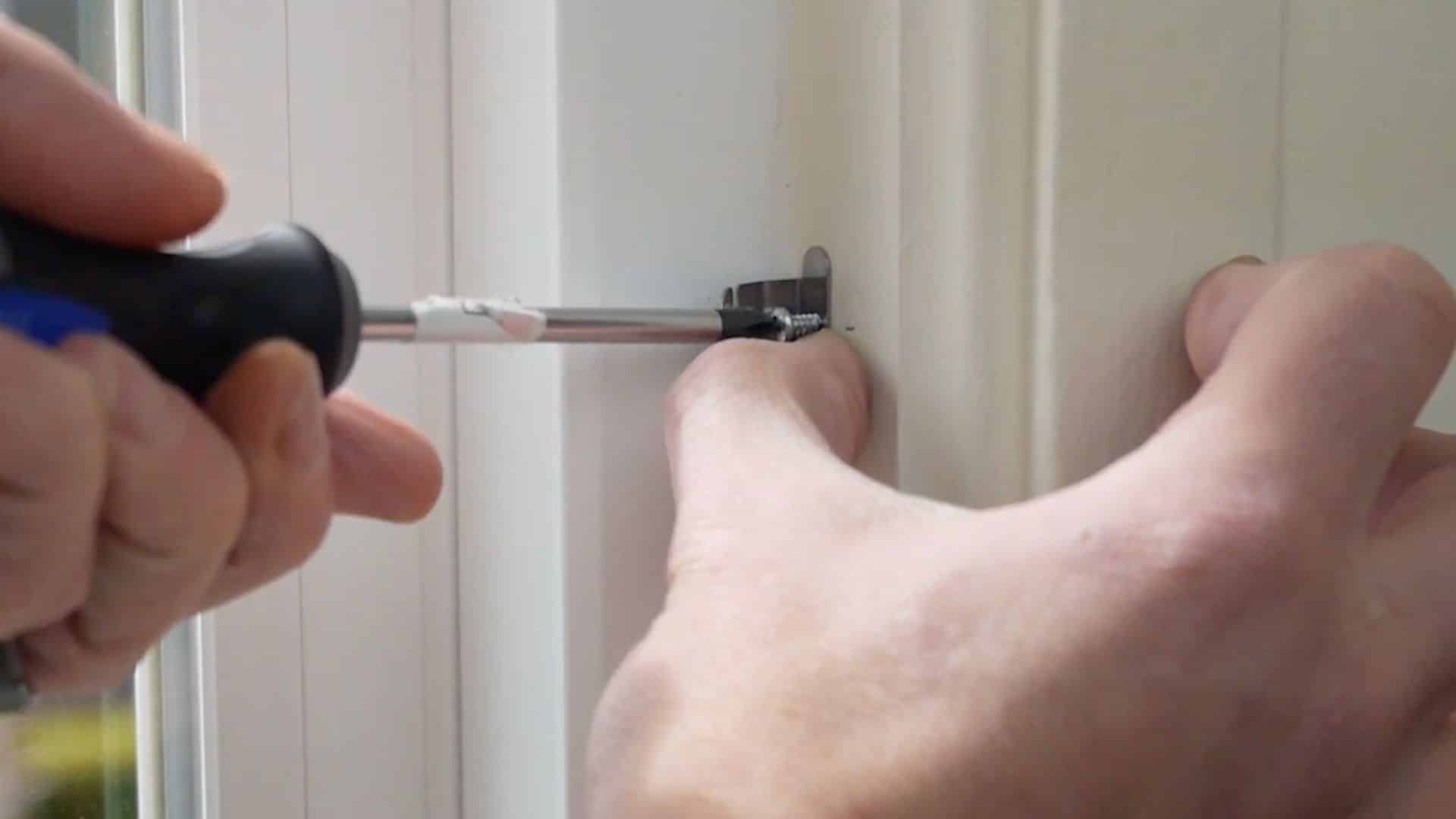 installing support brackets on window frame to hold insert securely in place