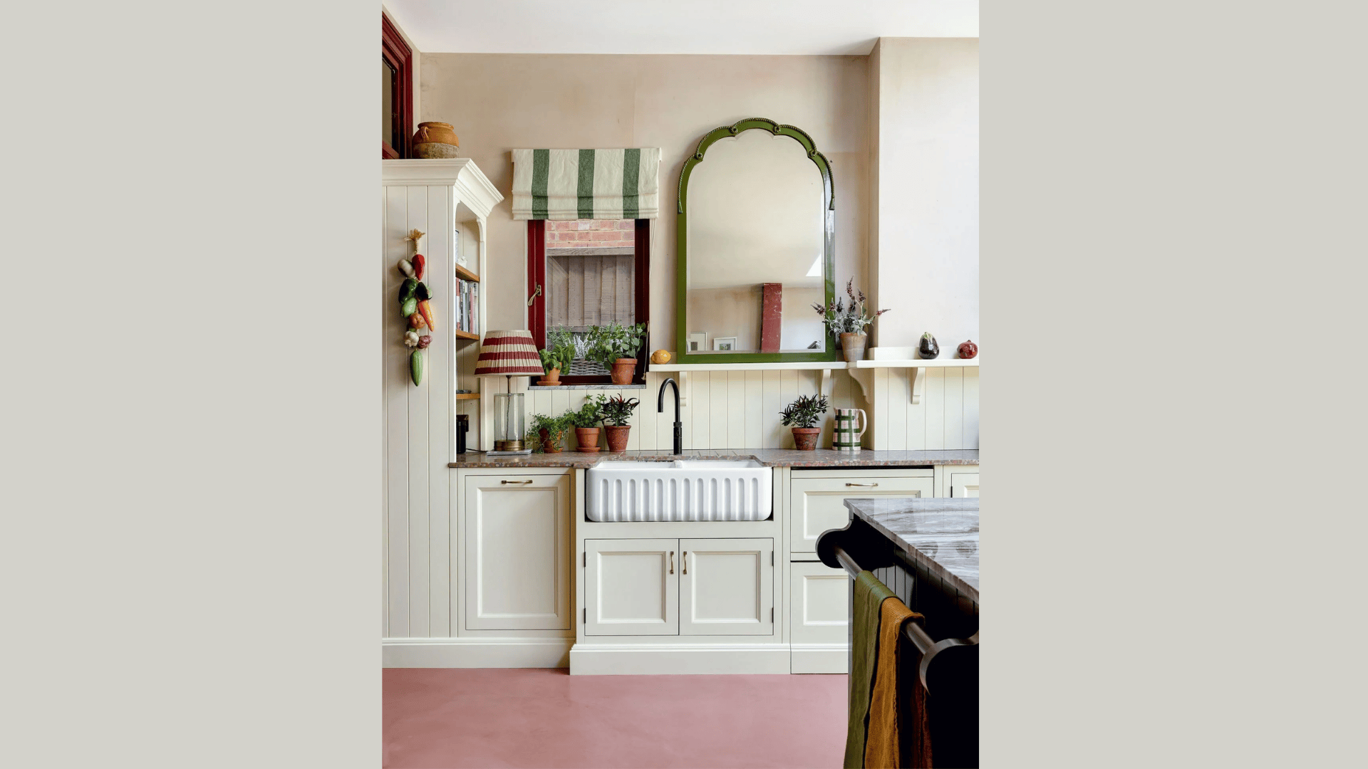 kitchen wall mirror above sink with plants and light cabinets creating bright space
