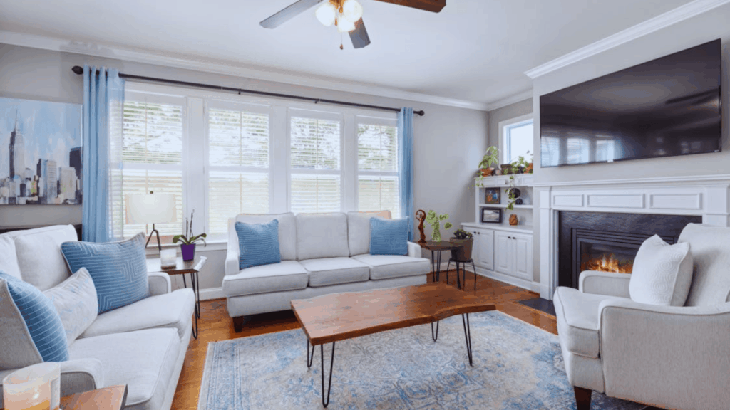 living room with sofa chairs coffee table and area rug in bright modern interior design