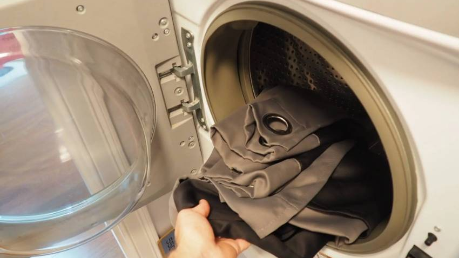 loading laundry into washer as part of house cleaning routine