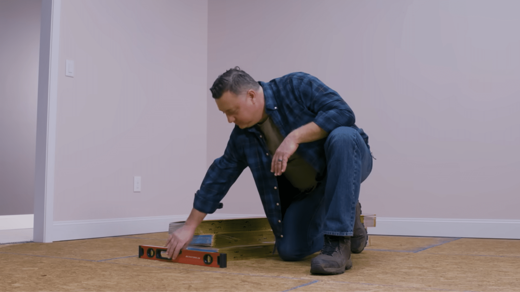 Measuring floor space with tape for laminate flooring installation planning