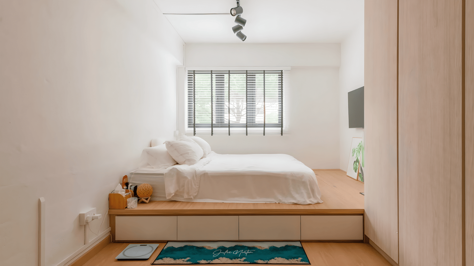 Minimalist white bedroom with platform bed, wooden floor, large window and simple decor creating clean mens room decor style