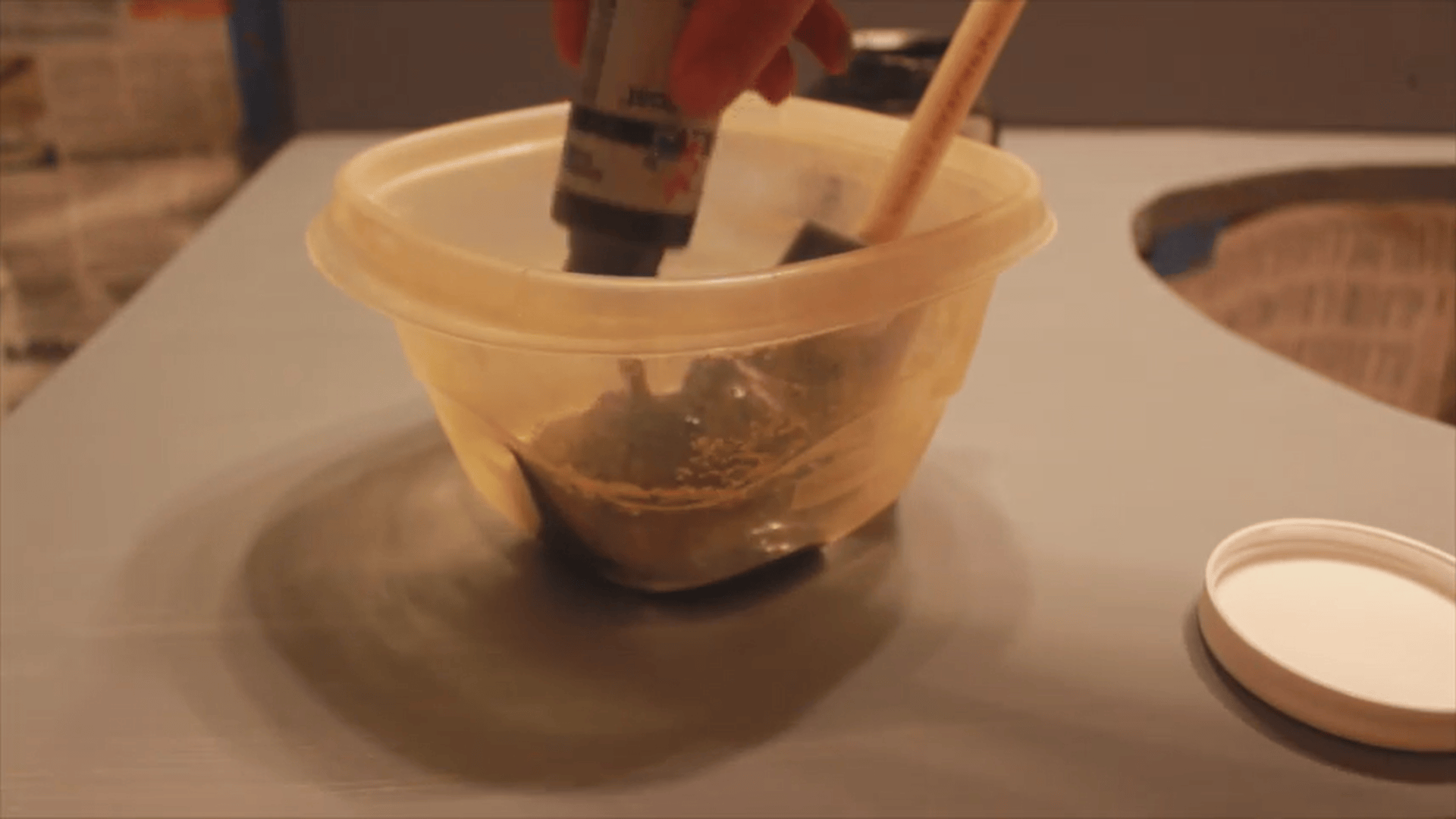 Mixing coating in bowl on countertop surface for resurfacing laminate countertops process