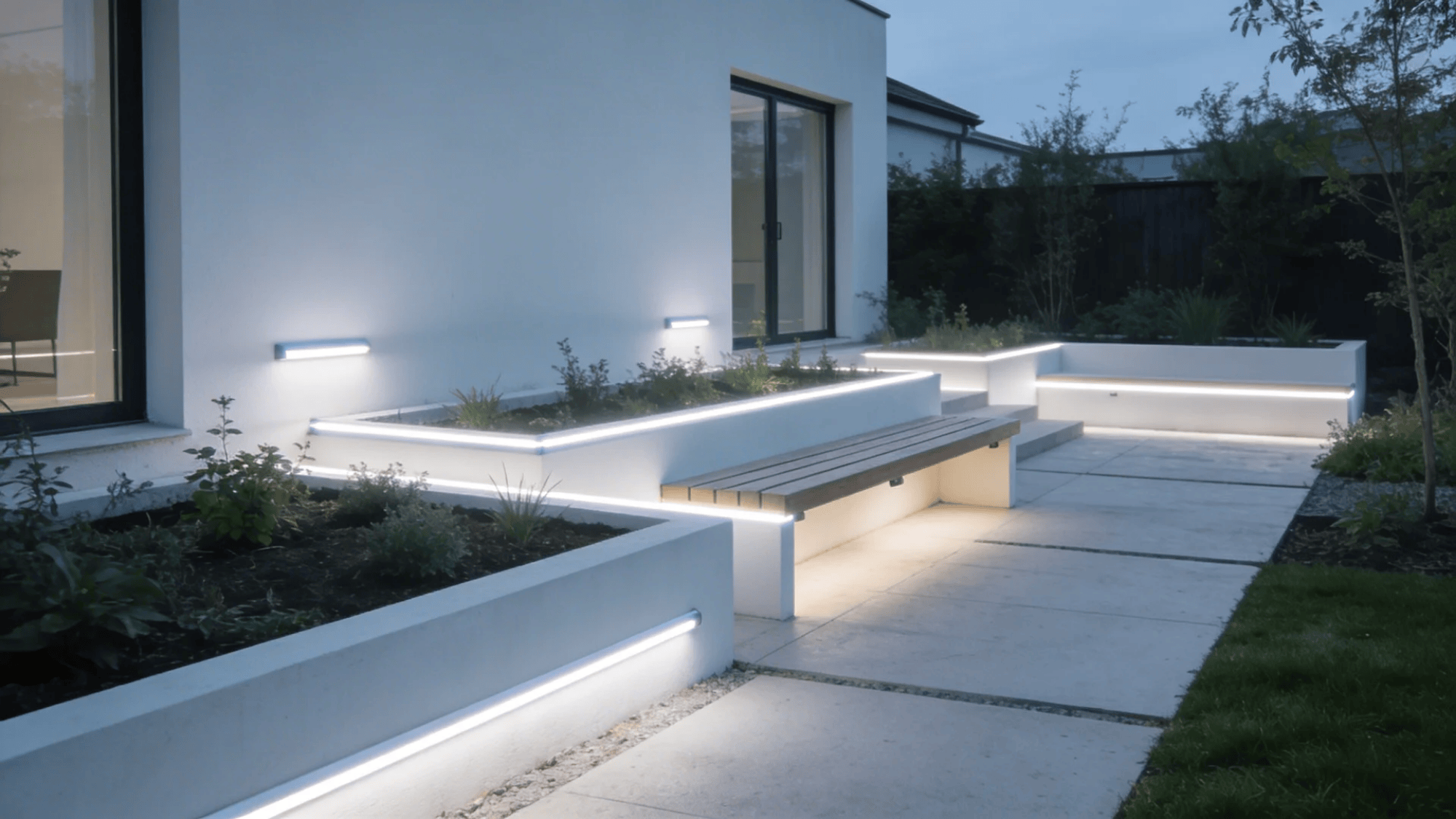 modern backyard with built in led lights along benches and planters creating clean night look