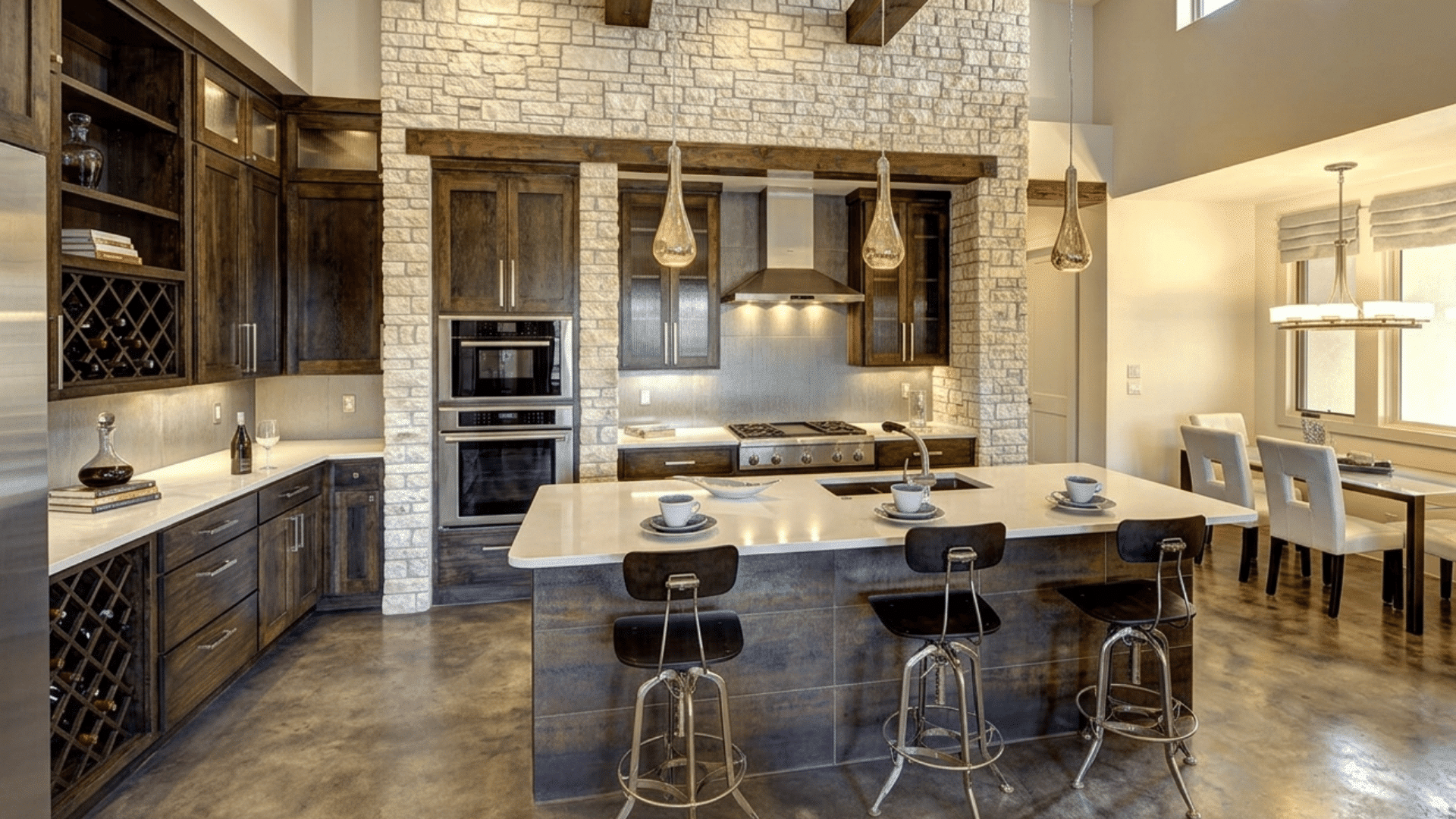 modern farmhouse kitchen with stained concrete floors dark wood cabinets and white stone walls