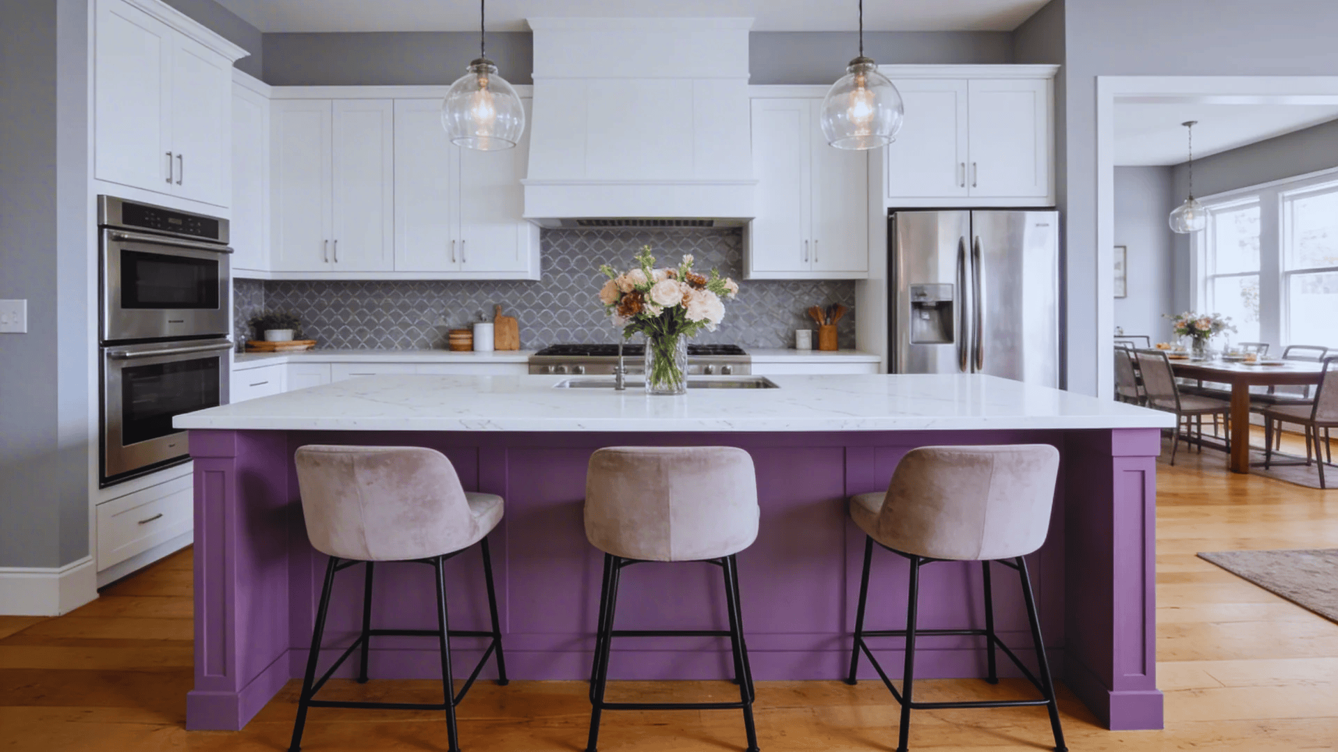 modern kitchen with white cabinets purple island seating gray backsplash and stainless steel appliances