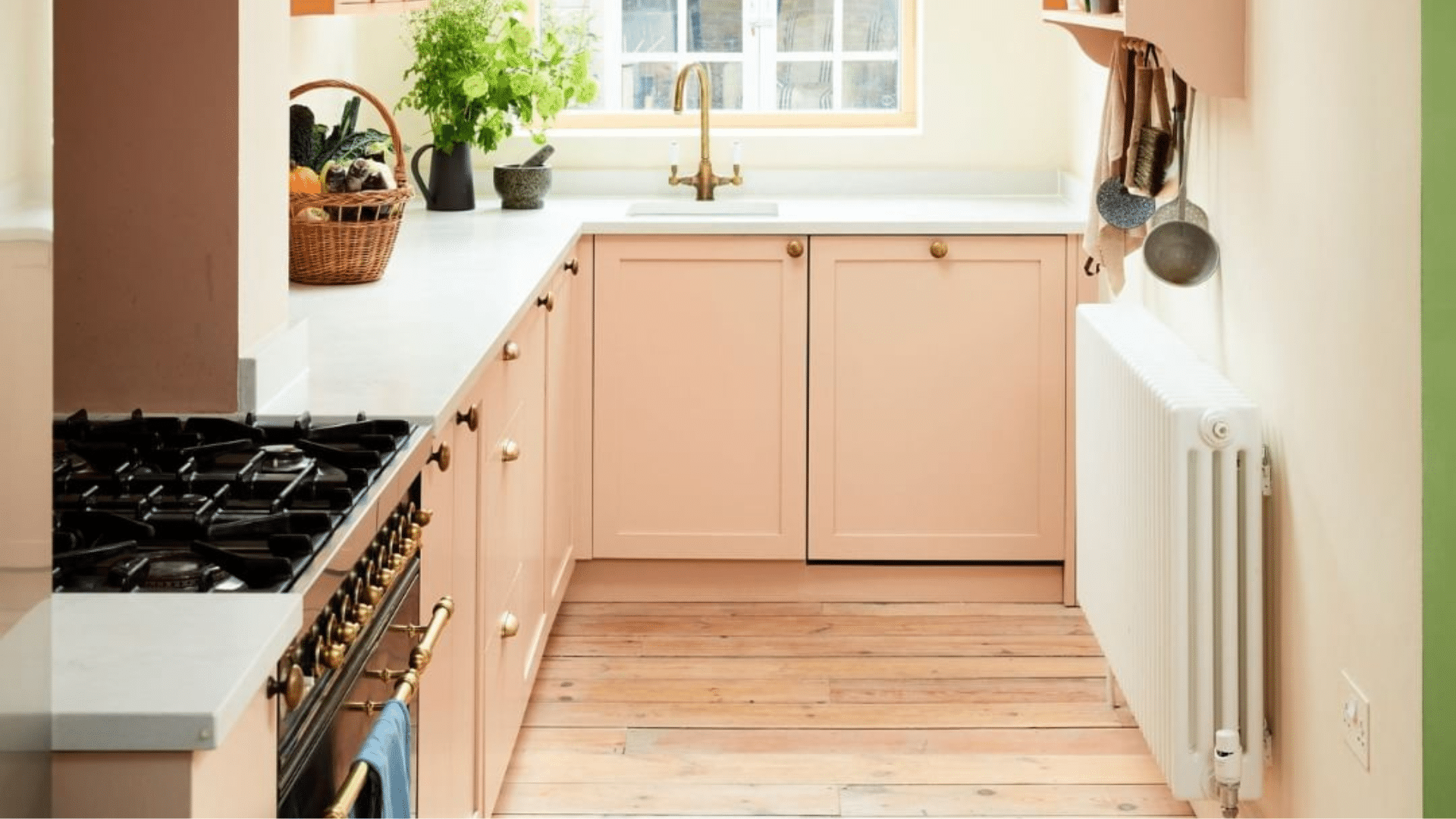 peach cabinet galley kitchen with window and wood floor