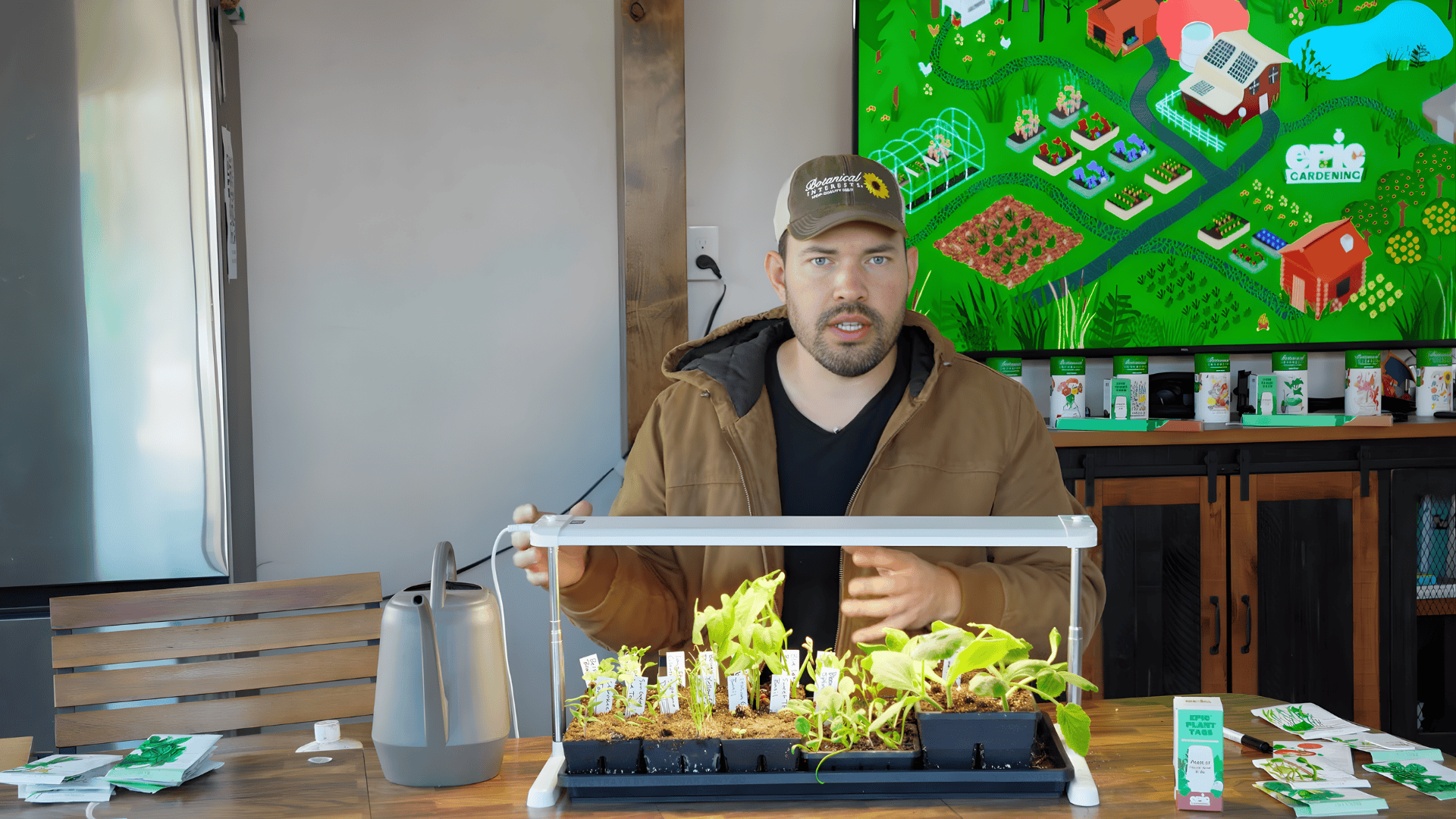 person explaining indoor seed starting setup with grow light and seedlings how to start seeds indoors