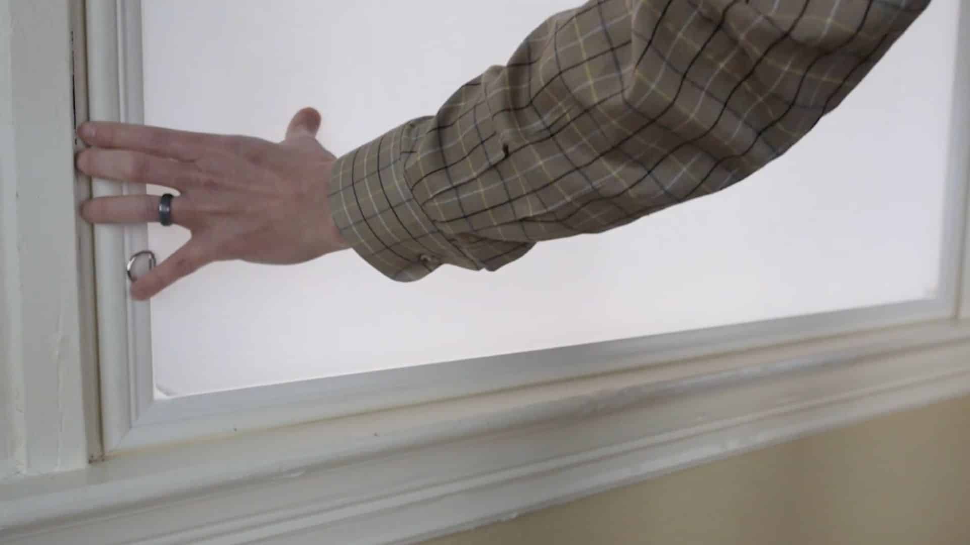 placing window insert carefully into frame ensuring even pressure on all sides