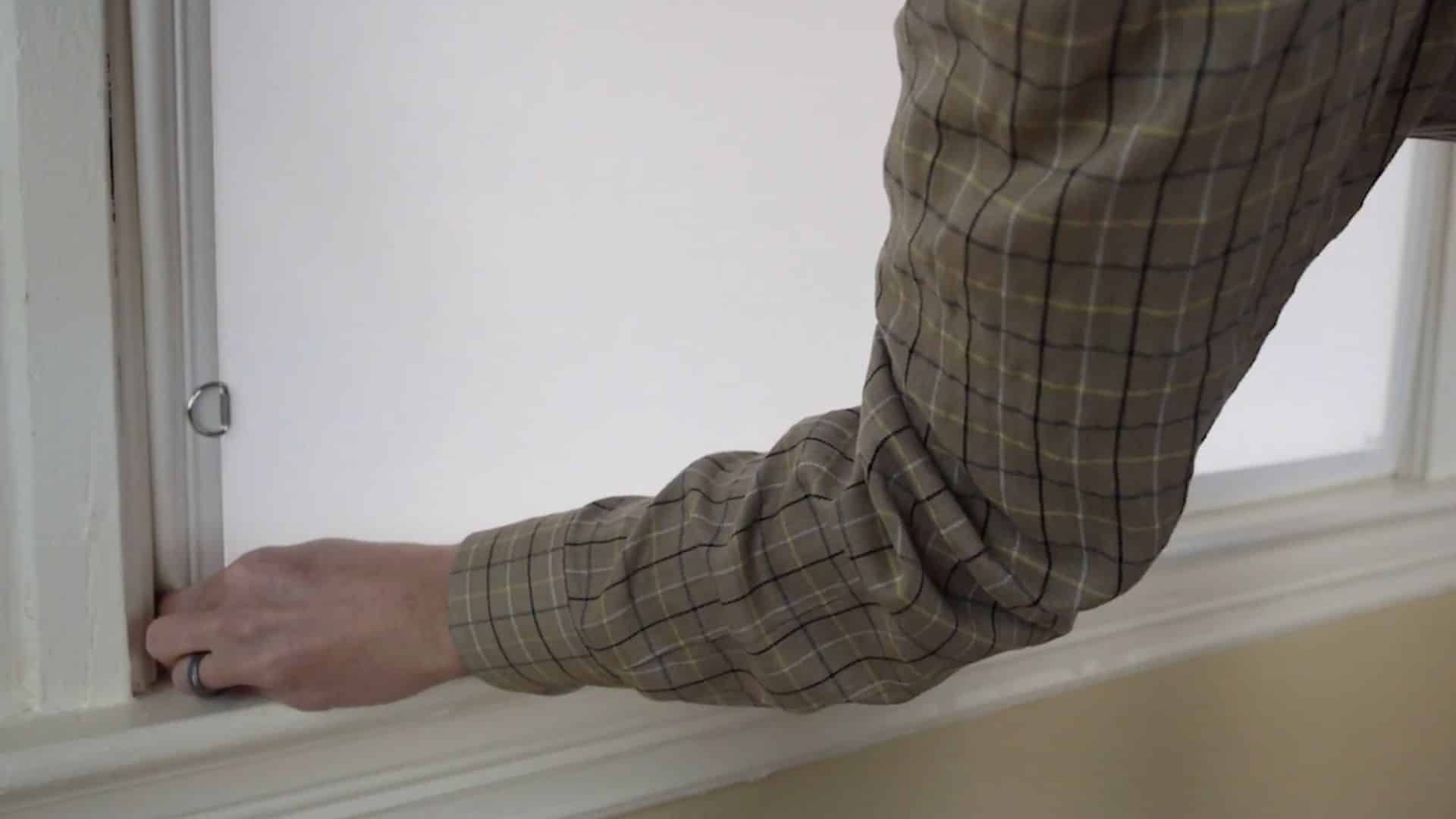 pressing window insert gradually into frame from bottom to top for snug fit