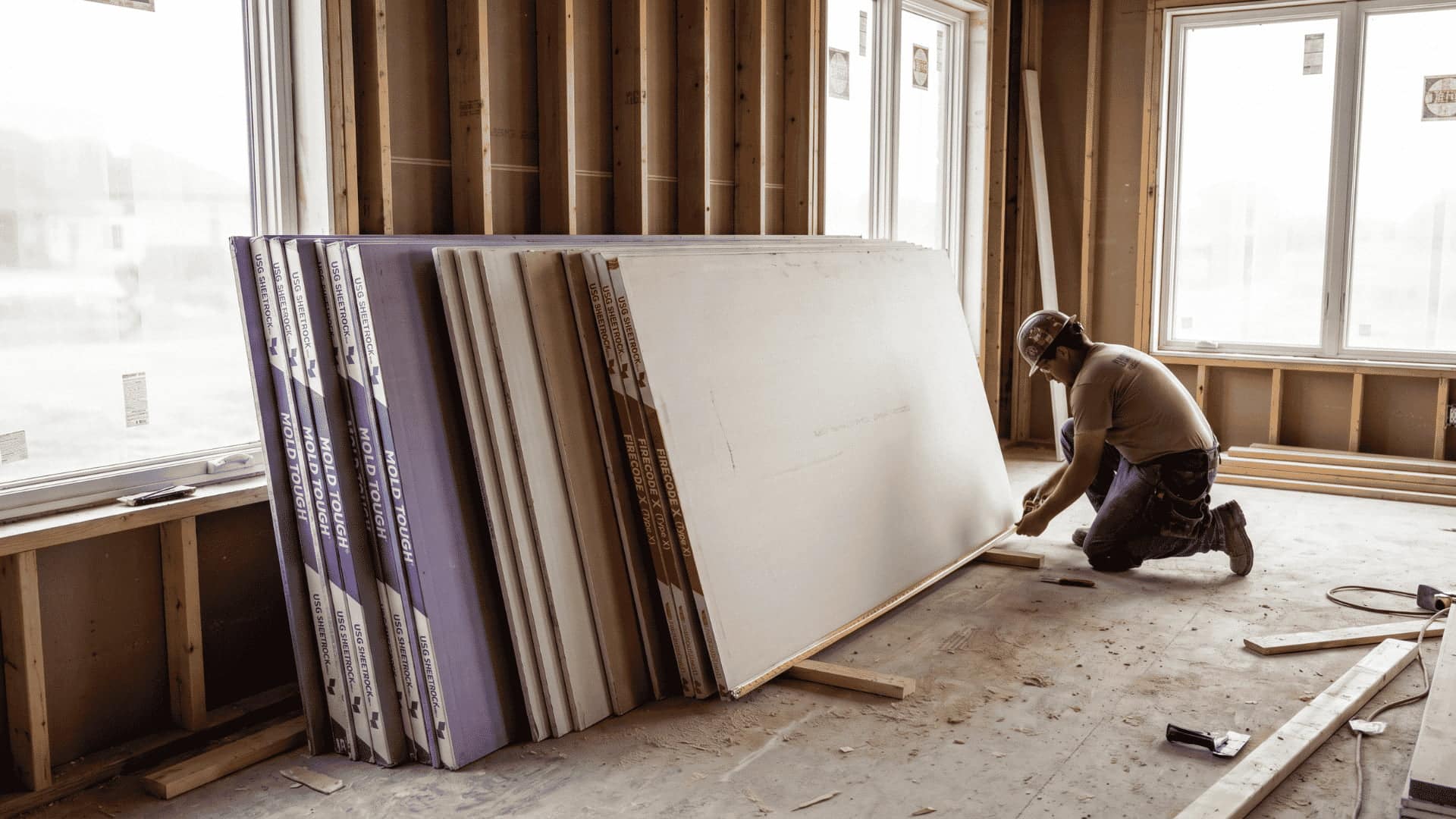 Stack of Sheetrock panels, including Mold Tough and Type X, ready for wall installation.
