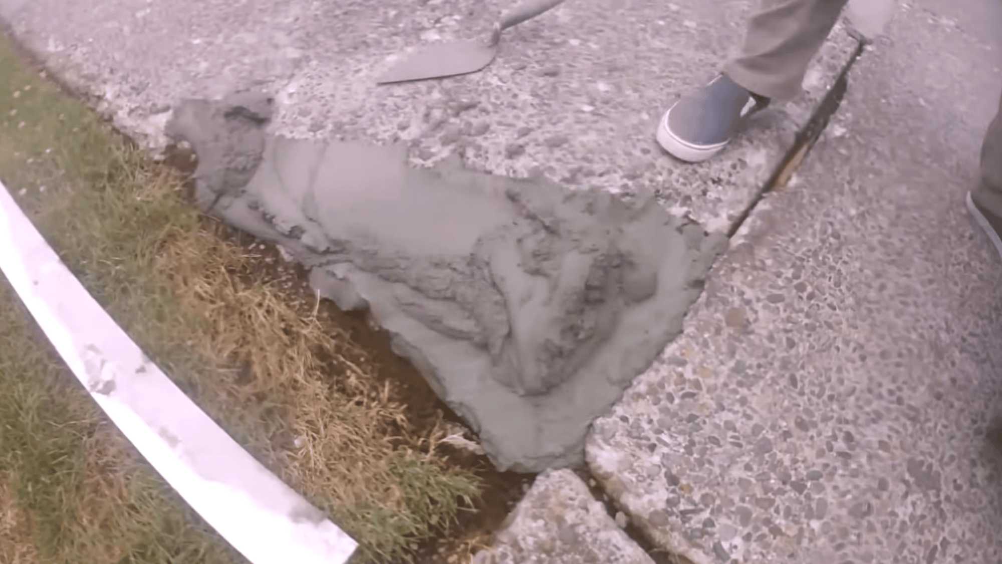 repairing large cracks and low sections during concrete driveway resurfacing preparation