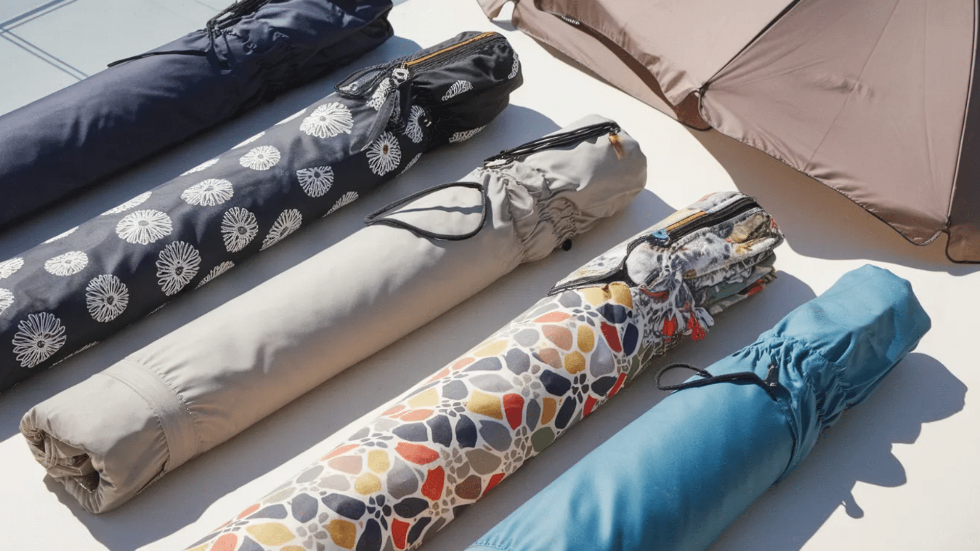 rolled umbrella covers with different colors and patterns