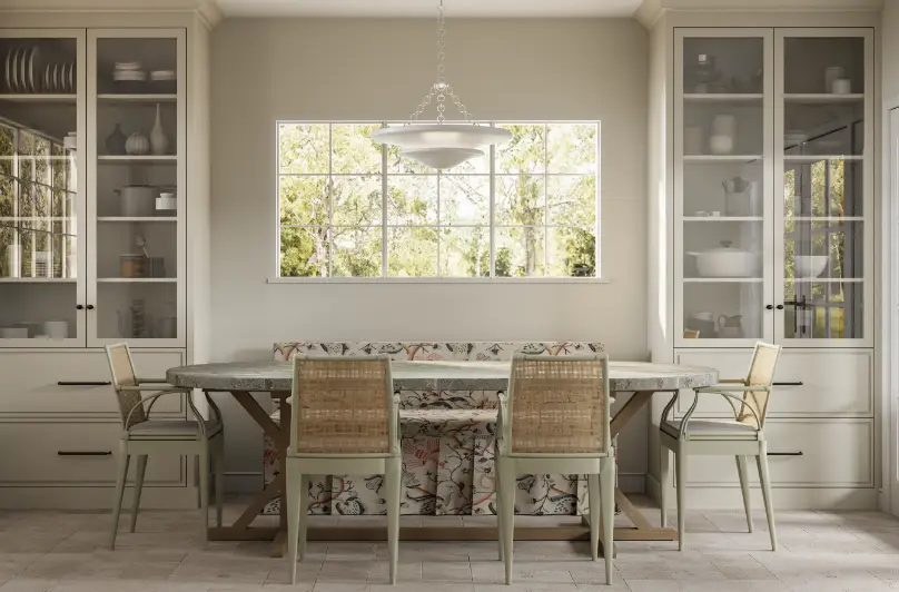 Dining room with a long table, patterned bench, and wicker chairs under natural light