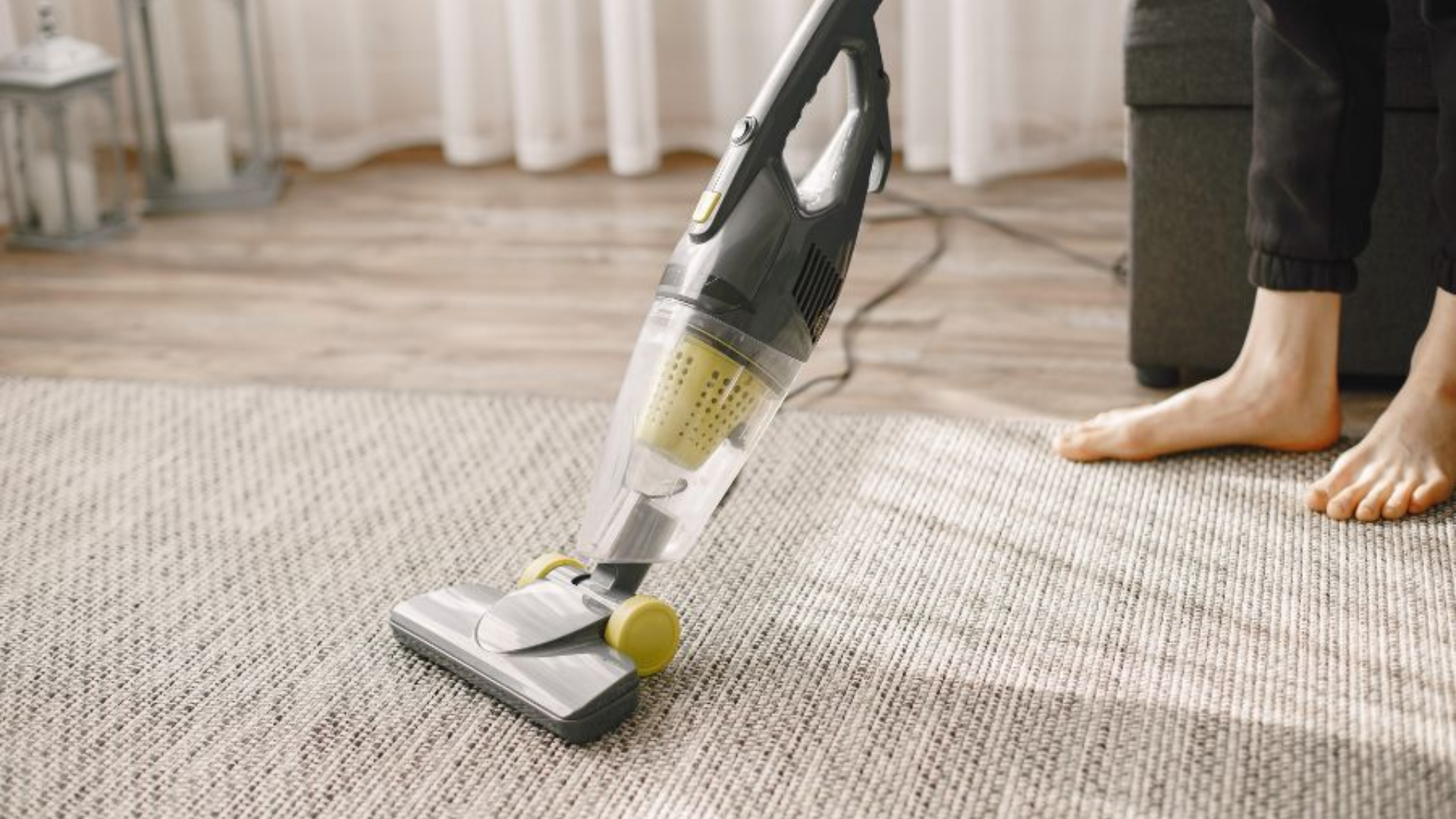 vacuuming carpet as part of weekly house cleaning routine