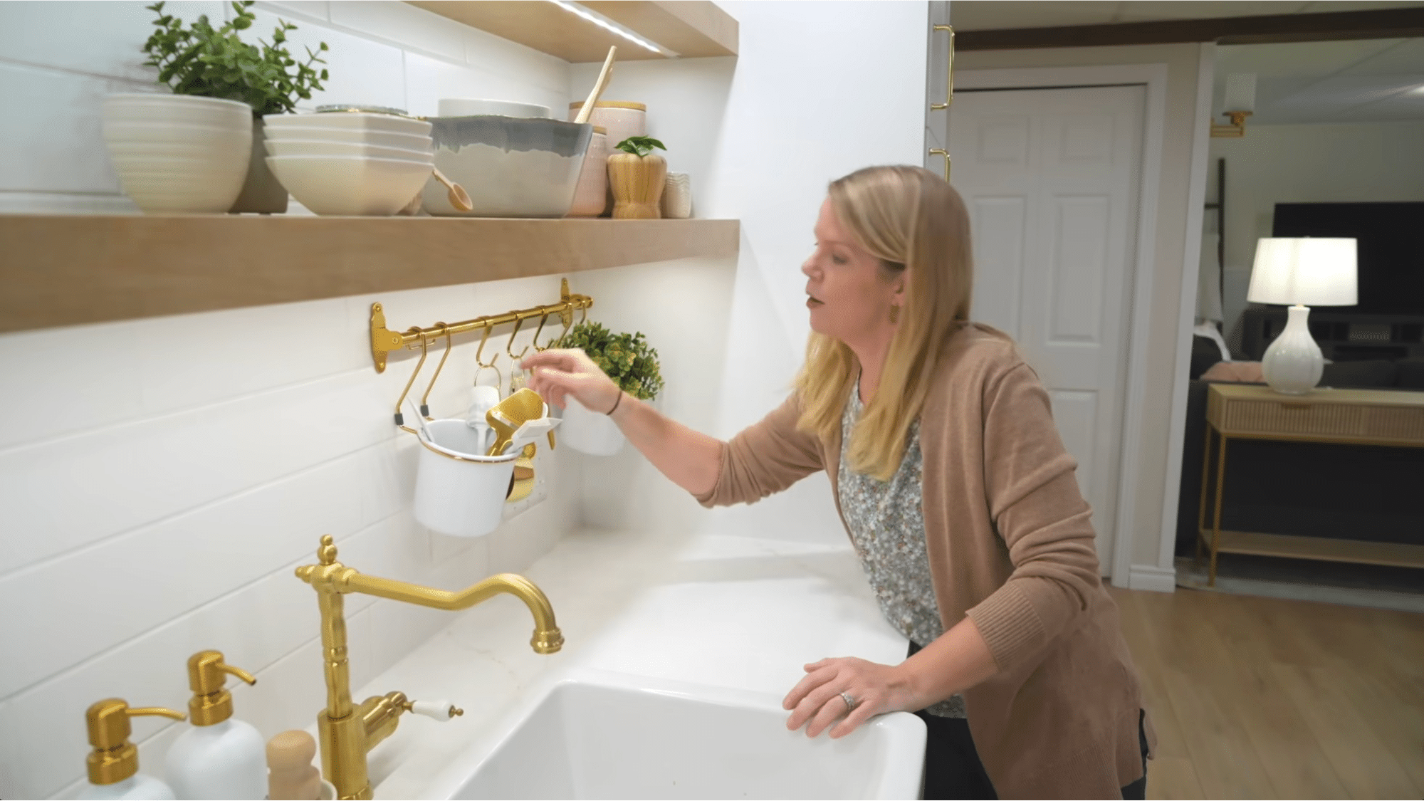 wall mounted rod with hanging containers near sink showing smart vertical storage for how to organize your home efficiently