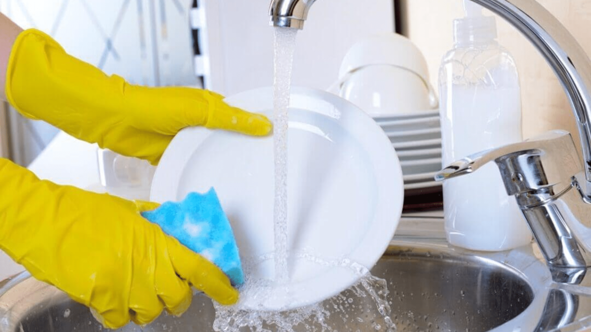 washing dishes at sink part of daily house cleaning
