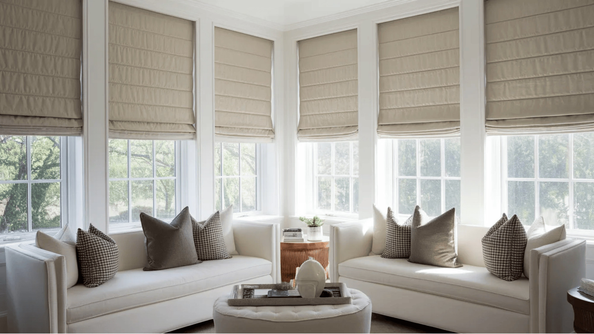 what is a roman shade light fabric roman shades covering wide bay windows above white sofas and round ottoman