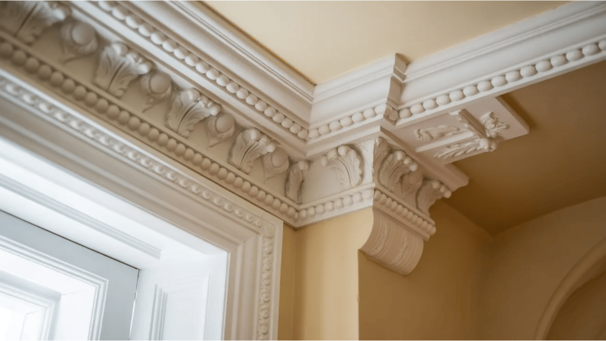 what is crown molding intricate white molding with decorative features on the top of the wall
