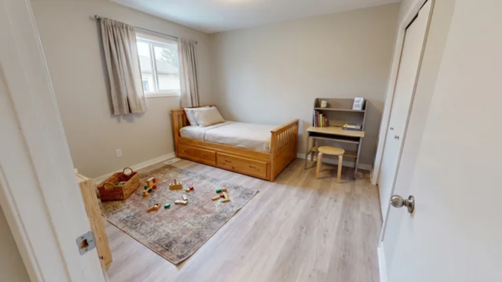 Twin bed with storage in a 10x10 foot bedroom used for sleeping and play