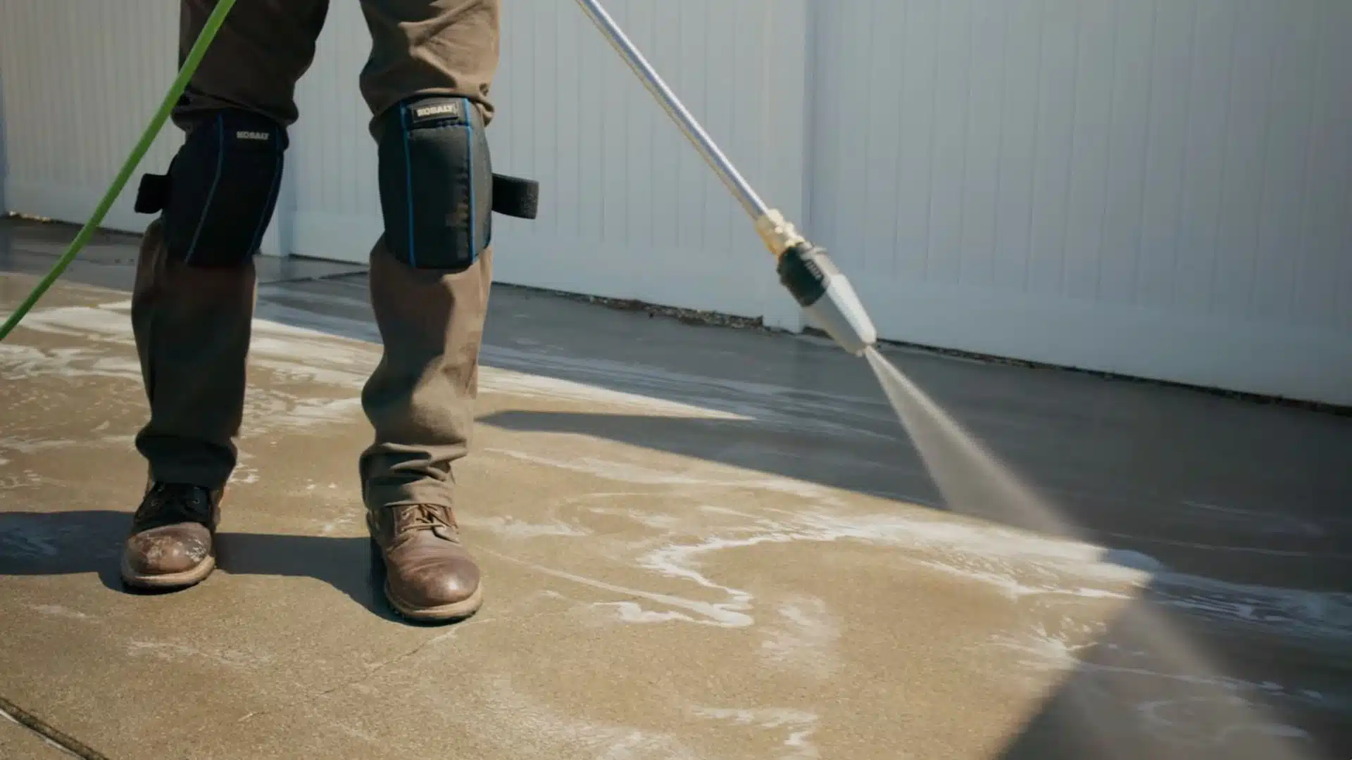 Concrete driveway cleaned with leaf blower and power washer, surface free of dirt and grease
