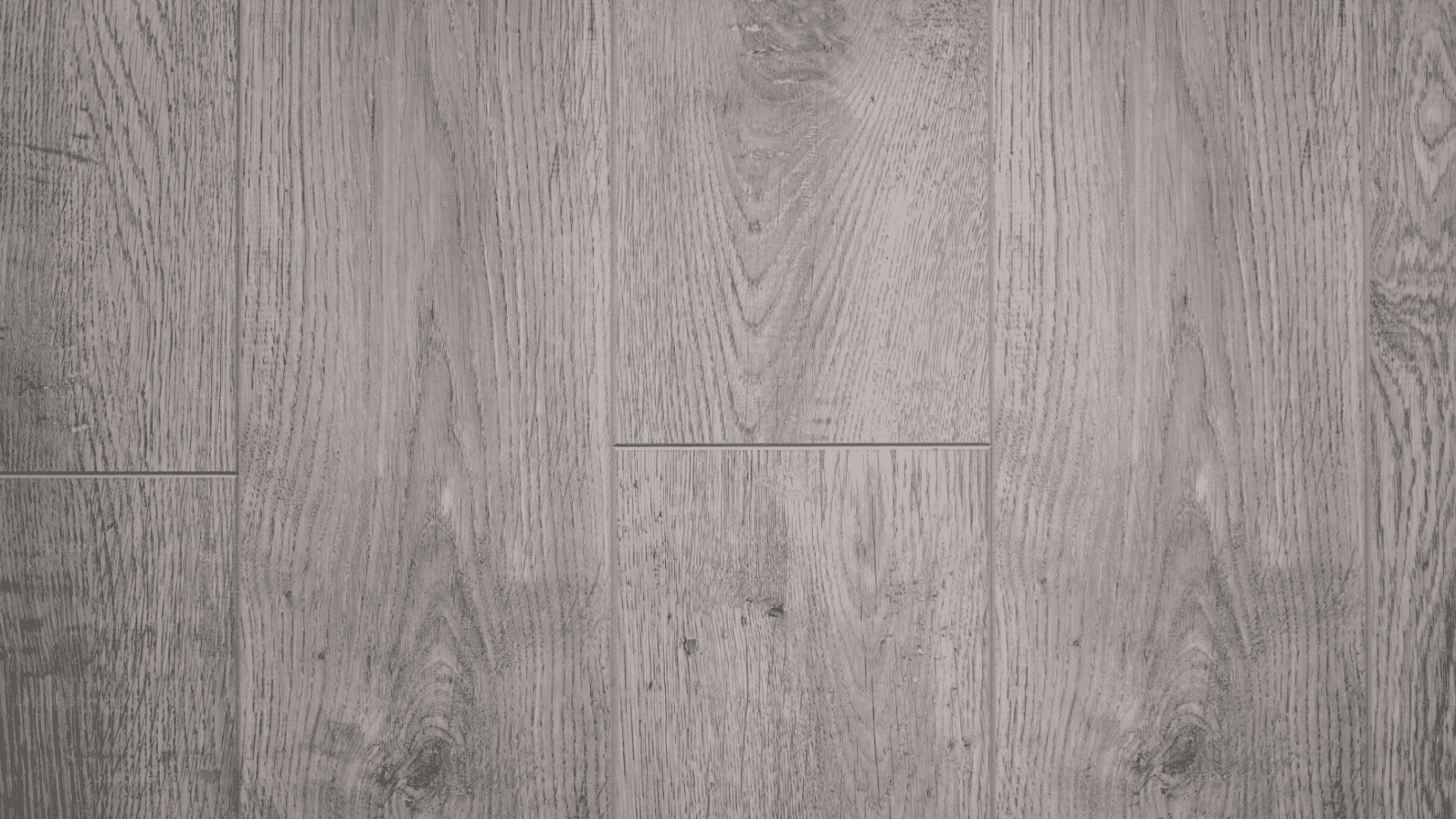 close view of light gray wood plank flooring showing natural grain texture and subtle weathered finish
