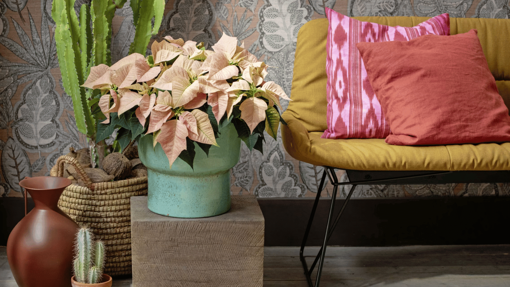 cozy reading corner with patterned wallpaper potted plants and a mustard chair with colorful cushions