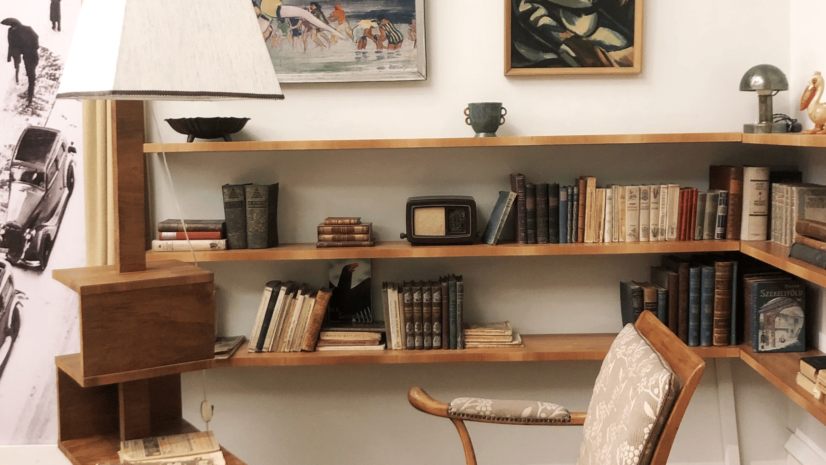 cozy reading nook with wooden bookshelves filled with vintage books a patterned chair and a classic table lamp