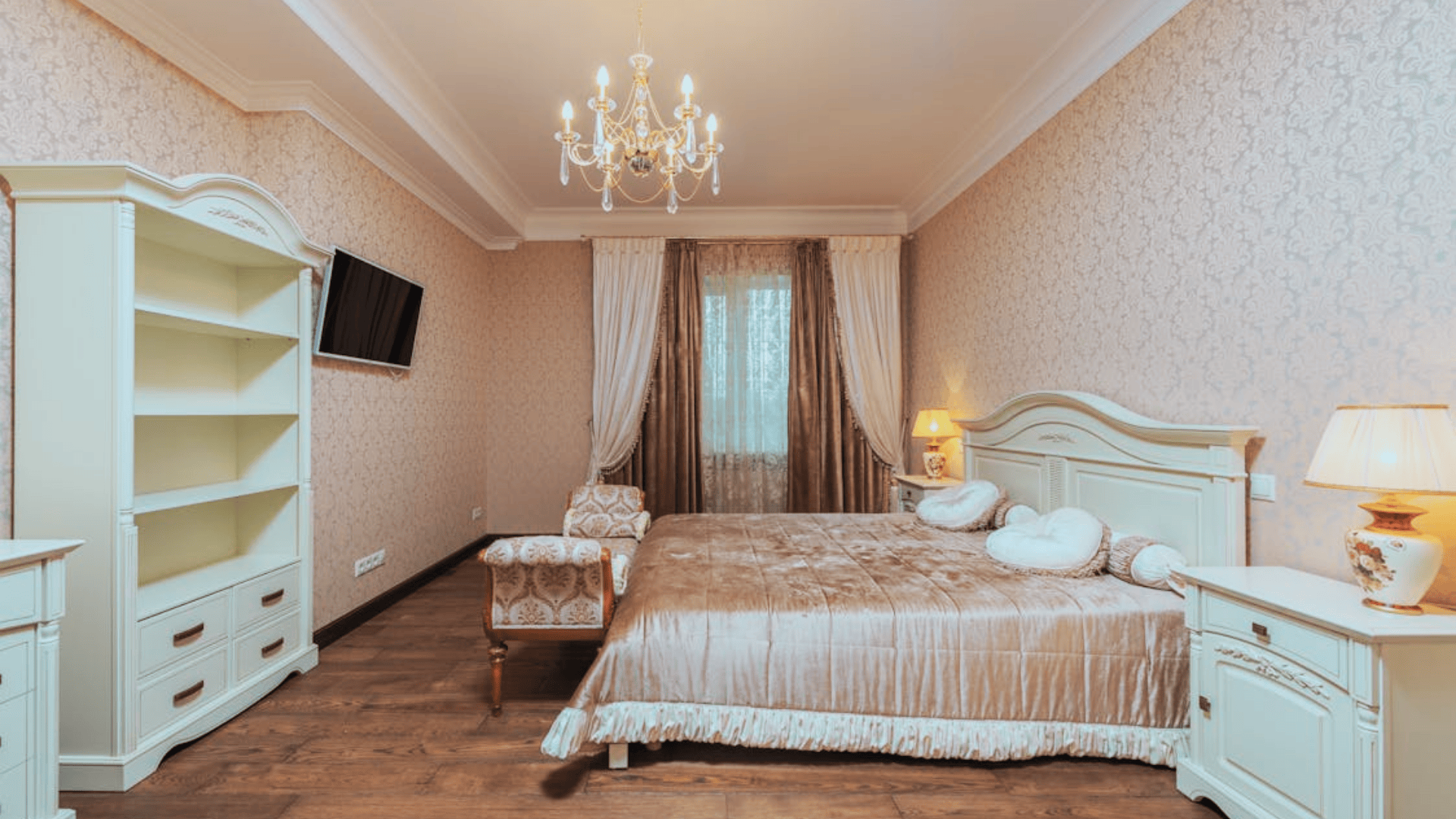 english cottage style bedroom with floral wallpaper sofa and soft lighting