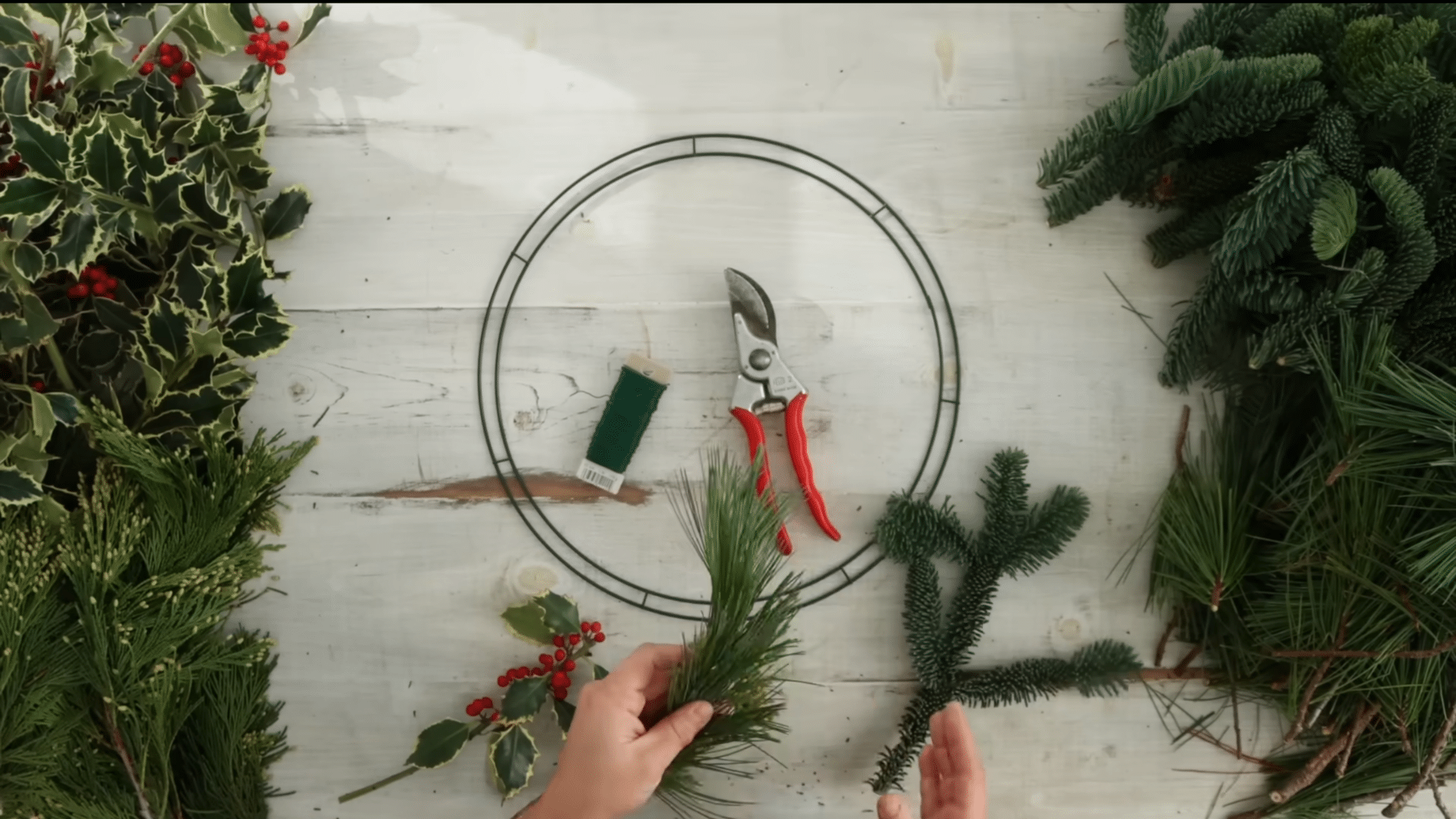 gathering wreath supplies with wire frame paddle wire pruning shears and fresh evergreen branches