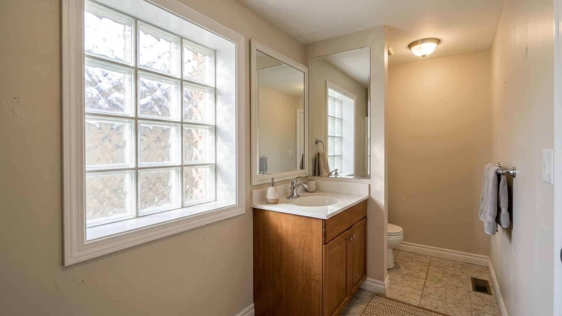 glass block window in basement bathroom with soft diffused light privacy and clean bright modern interior design