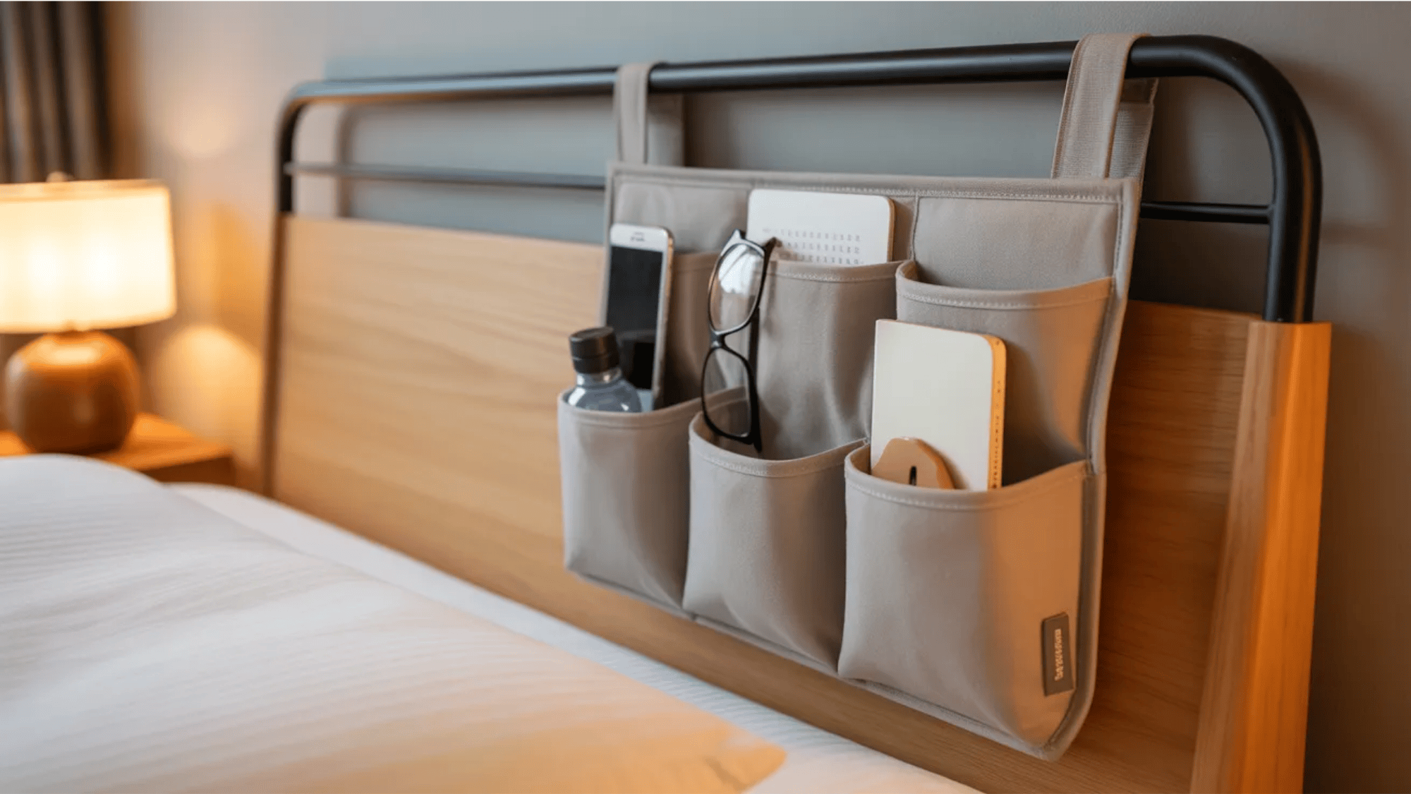 guest room ideas bedside hanging organizer holding phone glasses notebook and water bottle for convenient guest essentials