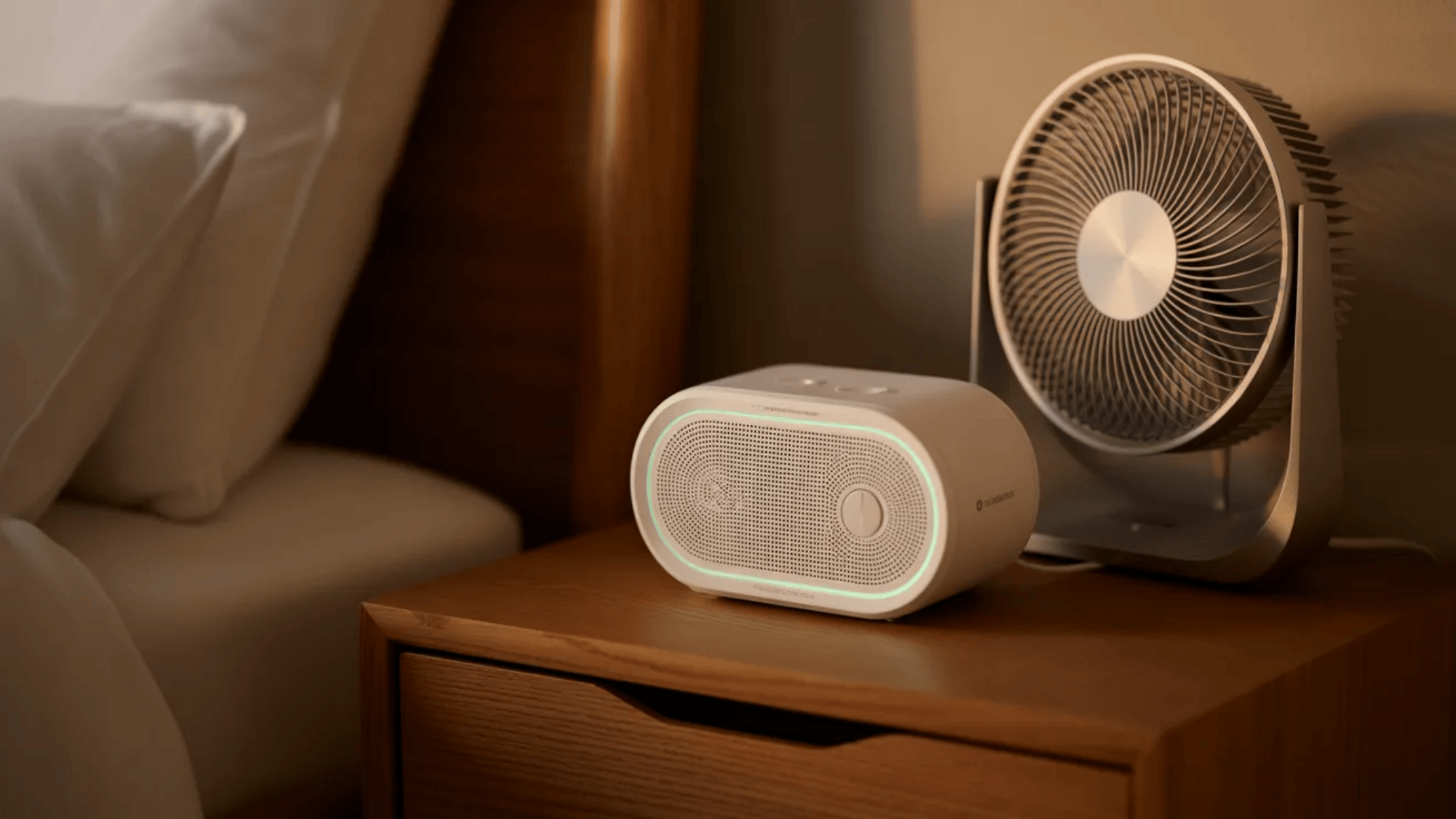 guest room ideas bedside table with small fan and white noise machine helping guests sleep comfortably through the night