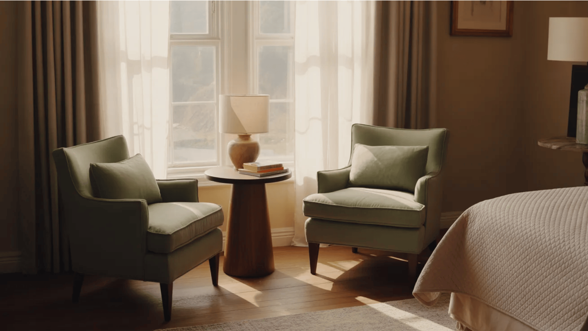 guest room ideas cozy seating area with two chairs small table and lamp beside window creating relaxing guest reading corner