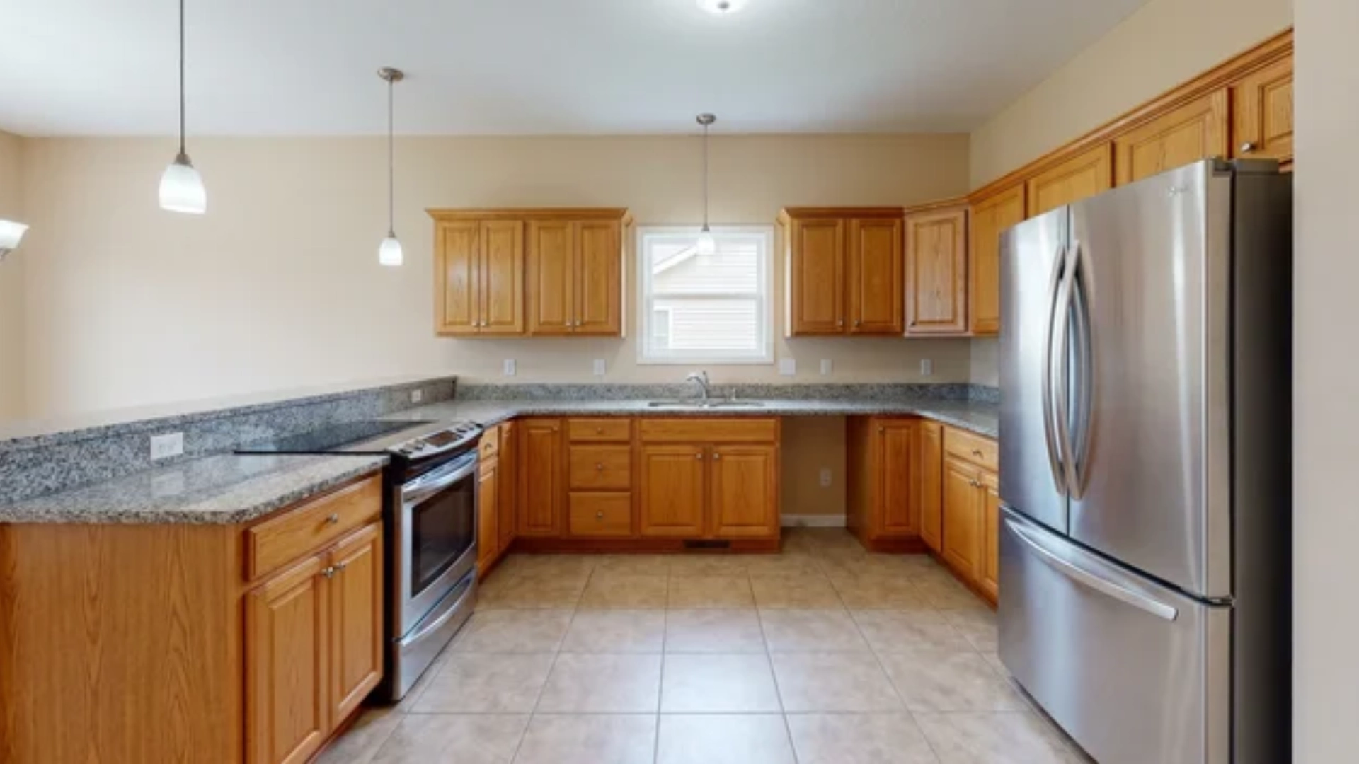 Kitchen showing refrigerator, sink, and cooktop arranged in a work triangle layout