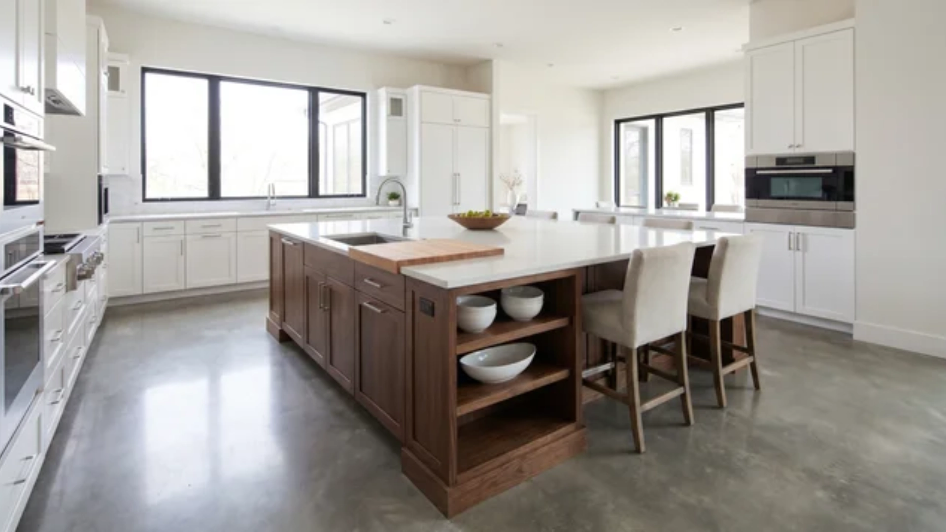 Kitchen interior with central island and clear surrounding walking space for prep and seating areas