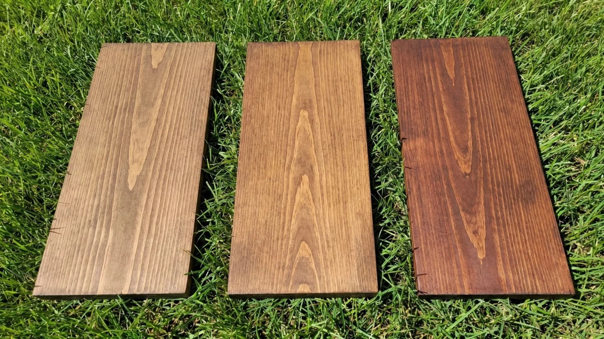 medium brown stained pine boards including walnut and chestnut placed on grass in natural light