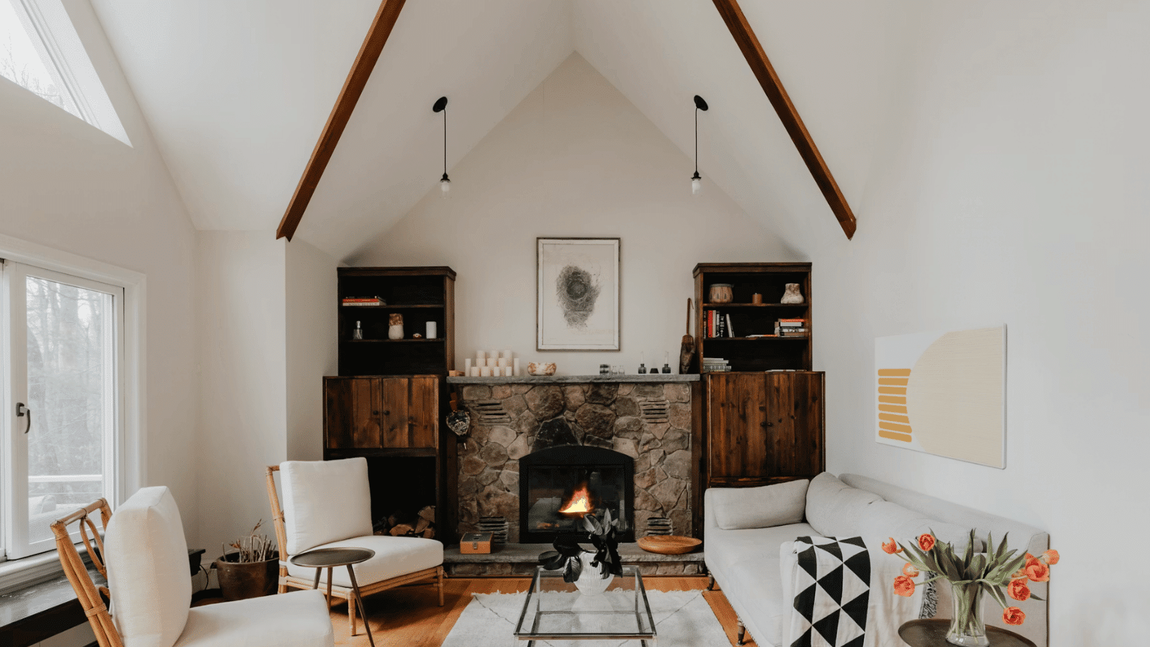 Modern living room with vaulted ceiling stone fireplace built in shelving and comfortable seating area