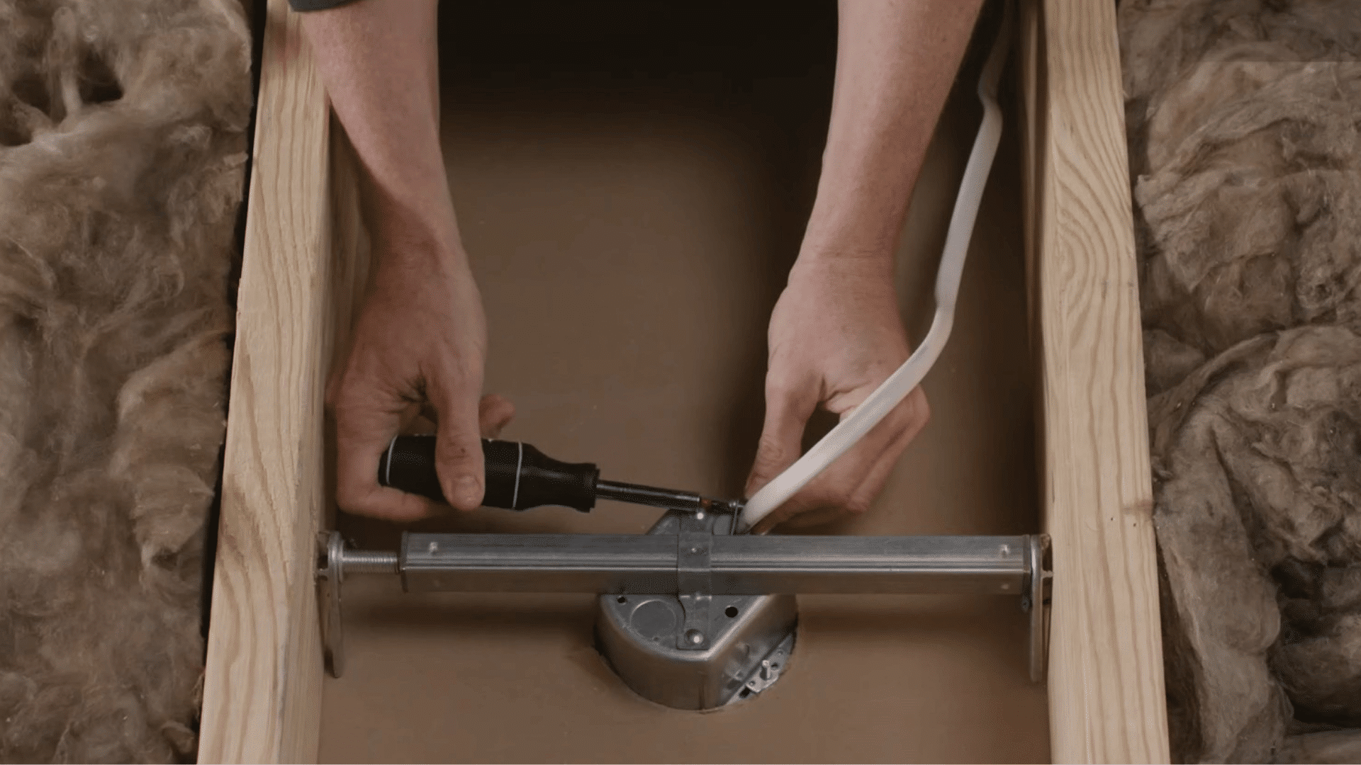 person cleaning ceiling fan blades with a duster to remove dust buildup before balancing the fan properly (1)