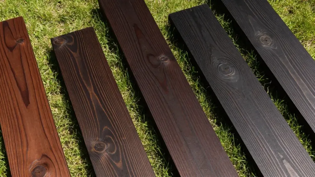pine stain samples arranged on grass showing pine wood finishes in natural daylight