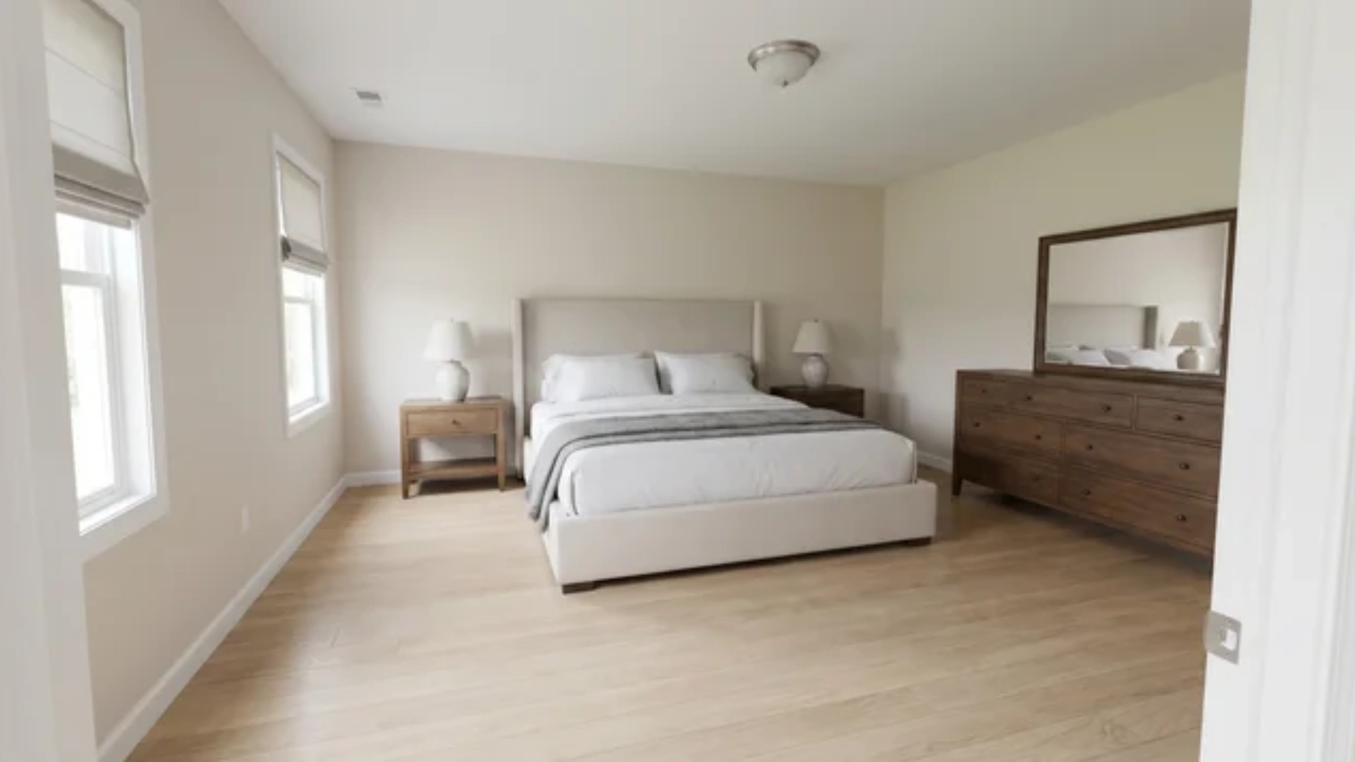 King-size bed with two nightstands and a dresser in a 14x16 foot bedroom with clear walking paths