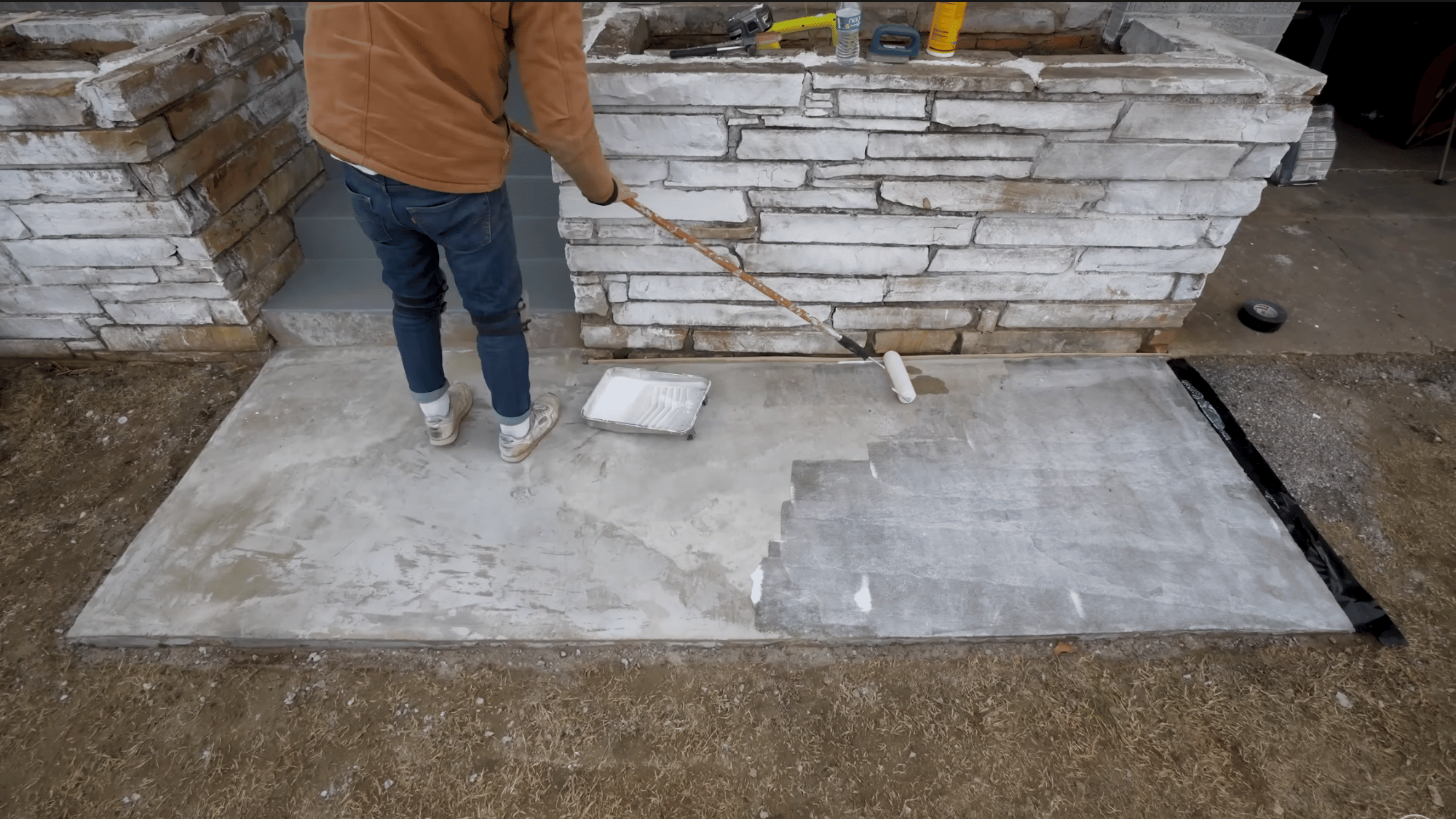 rolling bonding adhesive across repaired concrete to improve adhesion before applying resurfacer