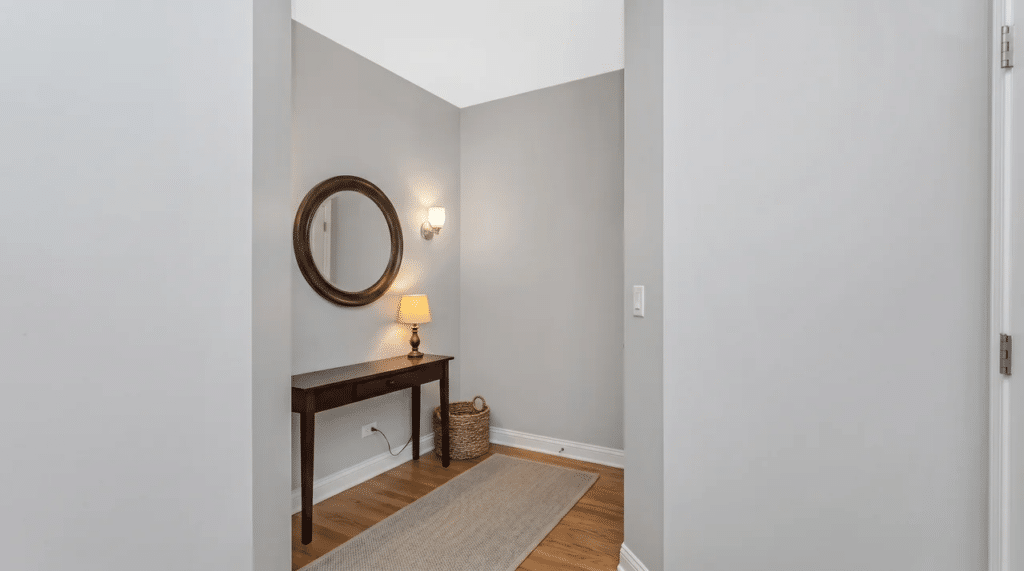 small entryway with mirror, console table, and pendant light