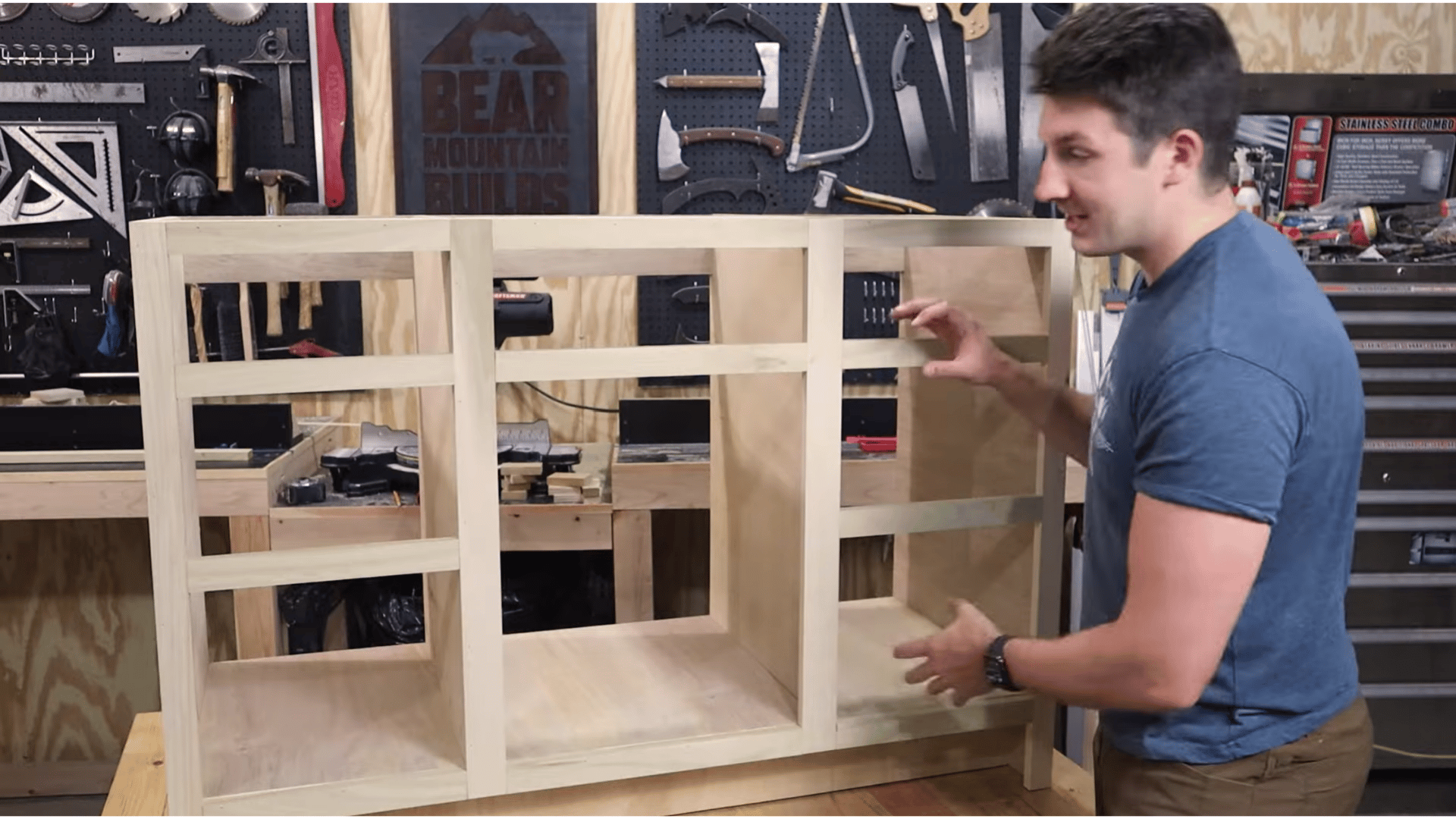 Attaching a wooden face frame to a DIY vanity cabinet structure in a workshop.