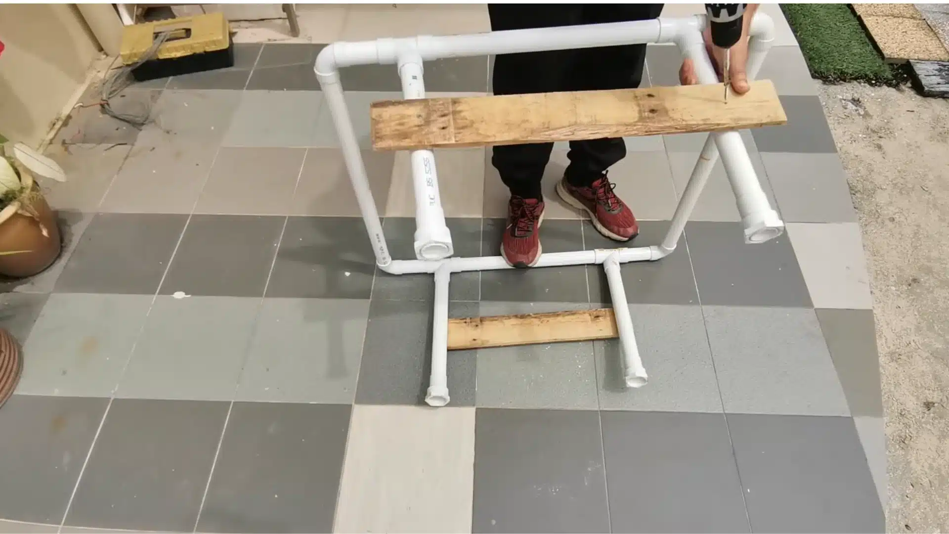 pvc pipe support structure for a diy hydroponic system with connected channels and elevated growing tubes