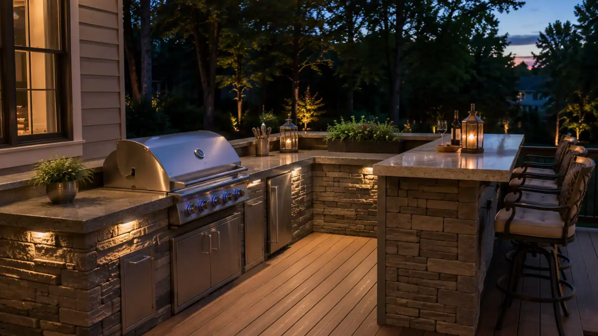 Built-in outdoor kitchen integrated into a backyard deck railing, with a stone prep counter and grill