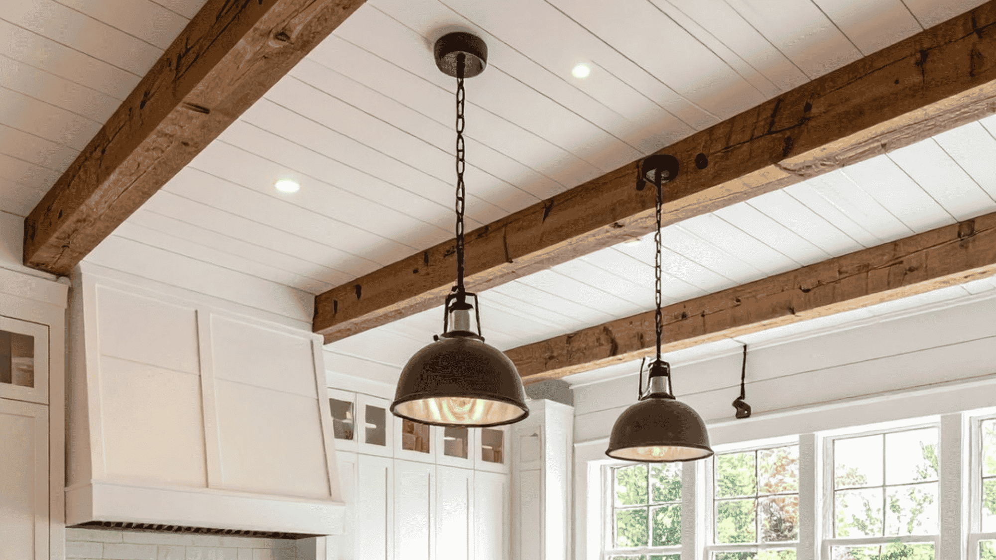 farmhouse tray ceiling with exposed wooden beams and white planks creating a warm inviting and timeless kitchen space
