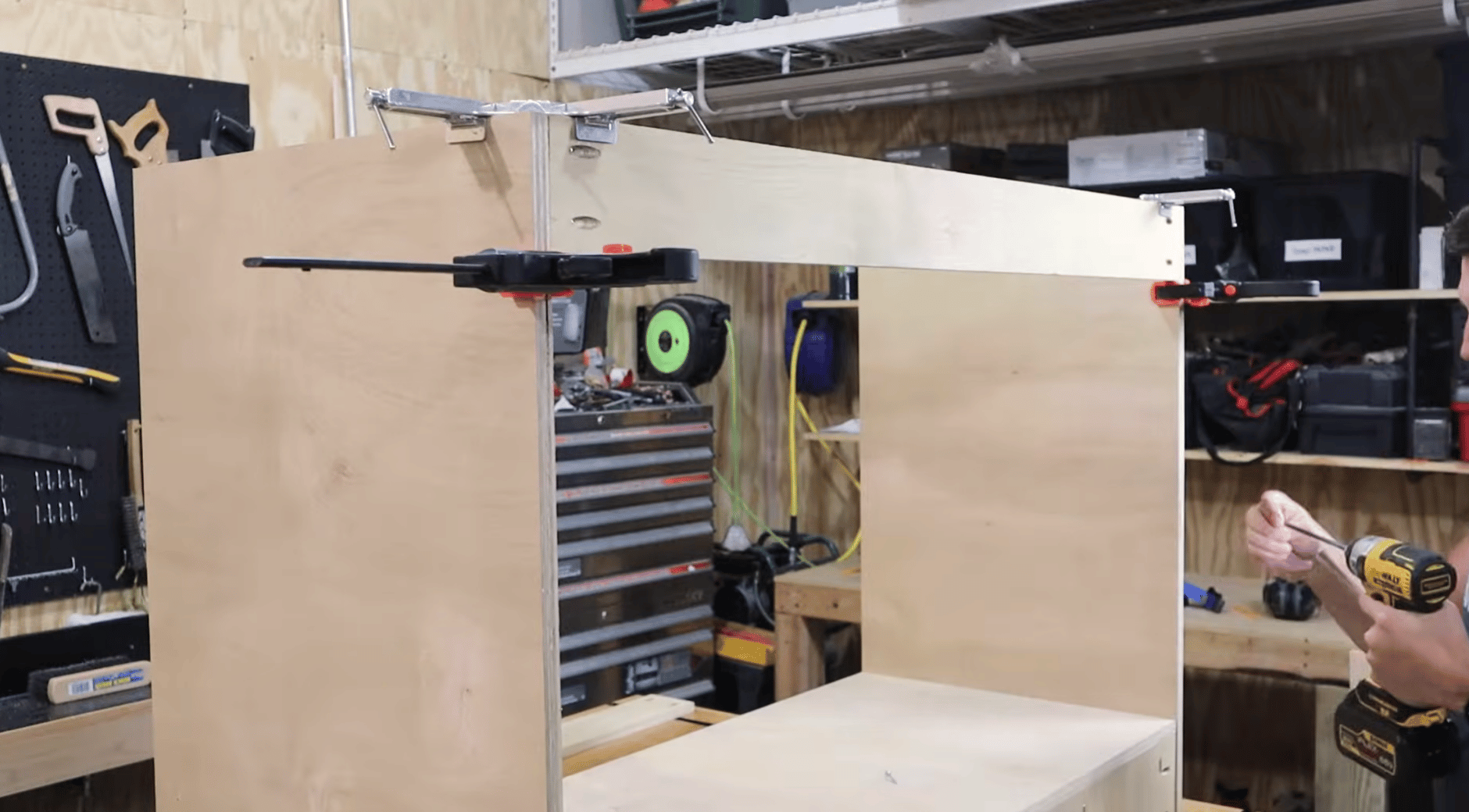 Constructing the plywood cabinet carcass for a custom bathroom vanity in a workshop.