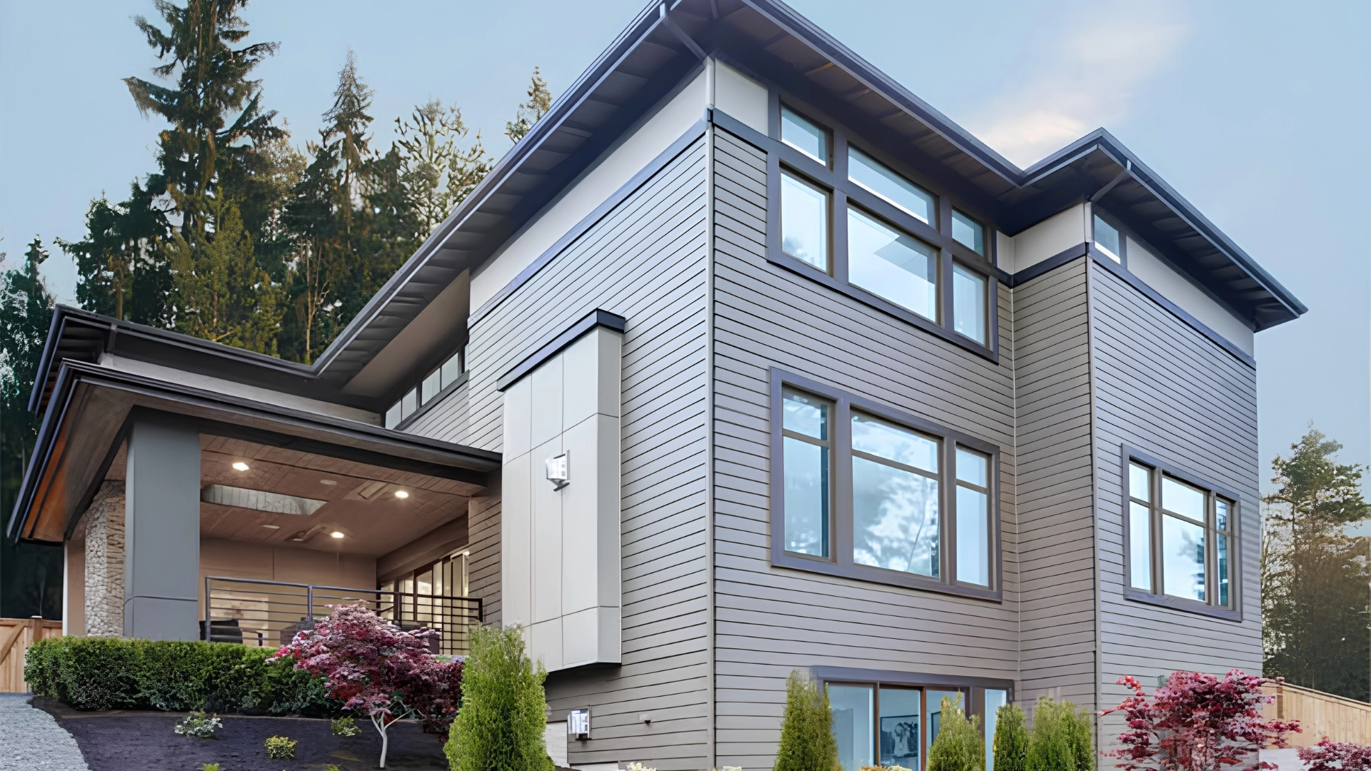 Exterior view of a modern two-story home featuring dark wood-clad custom windows.